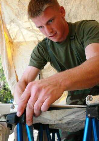 Pfc. Emil Reinwald, a decontamination technician with Company A, Chemical Biological Incident Response Force, II Marine Expeditionary Force, assembles the non-ambulatory decontamination line, so casualties on stretchers can be effectively decontaminated, during a training exercise at the McMillan Water Treatment Facility in Washington D.C., July 15, 2009. During a chemical, biological, radiological, nuclear, or high-yield explosive incident, many casualties will probably be unable to walk. So, CBIRF has a system, where Marines can decontaminate those who will be debilitated. Corpsmen and medical officers respond to chemical, biological, radiological, nuclear, and high-yield explosive incidents with CBIRF Marines and provide medical care in the contaminated area.