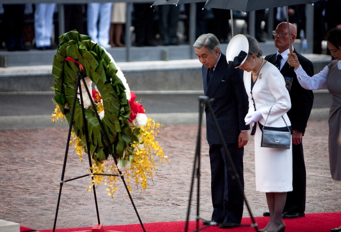 HONOLULU - Emperor Akihito and Empress Michiko of Japan bow their heads for a moment of silence at the National Memorial Cemetery of the Pacific July 15. The imperial couple visited Punchbowl Cemetery to lay a wreath on their first full day after arriving on the afternoon of July 14. (Official U.S. Marine Corps photo by Lance Cpl. Achilles Tsantarliotis)(Released)