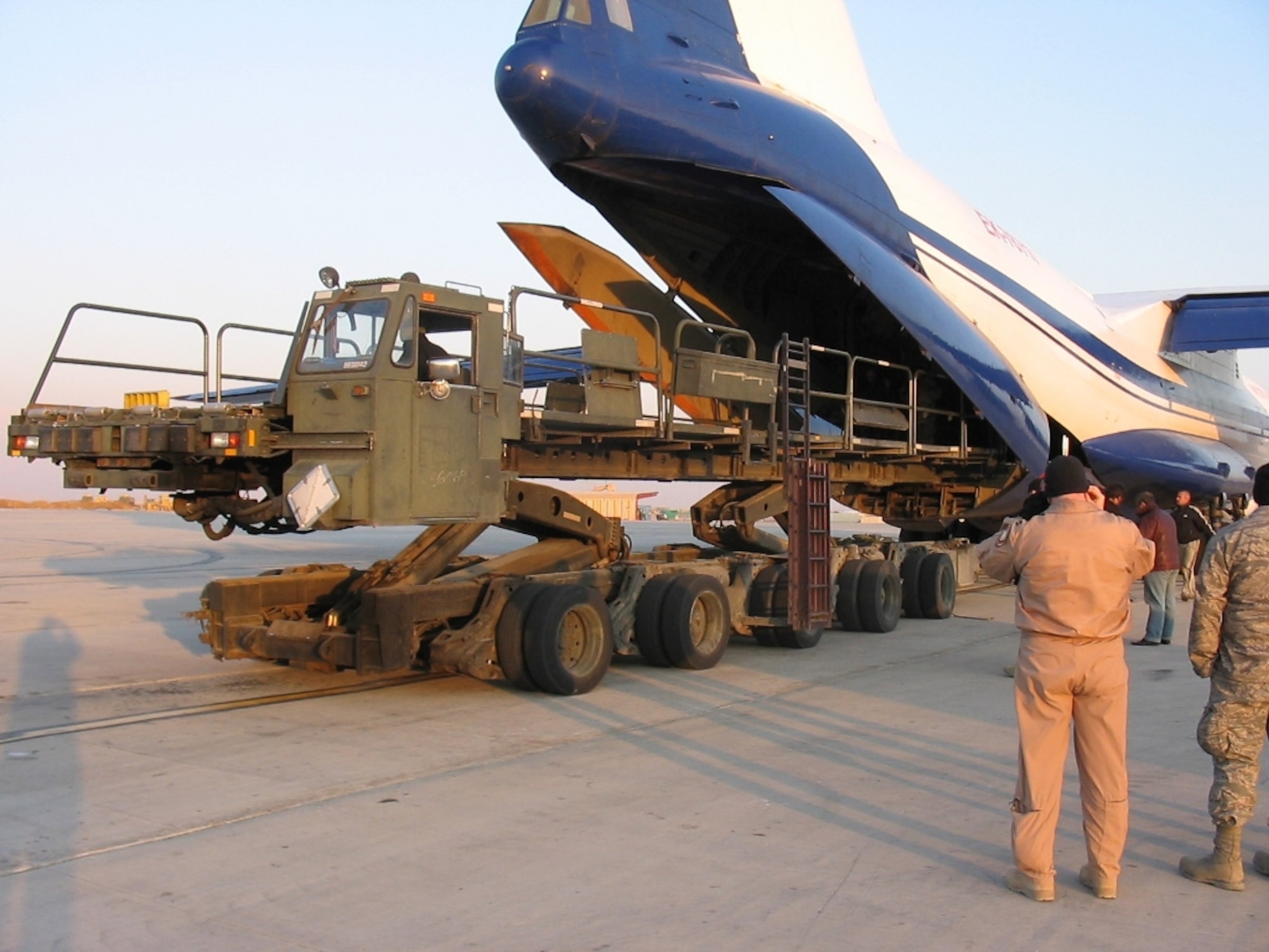 Members of the March Air Reserve Base 56th Aerial Port Squadron, deployed to Bagram Air Base in Afghanistan, use a 60K Aircraft Loader to load a Russian IL-76 aircraft. (U.S. Air Force photo)