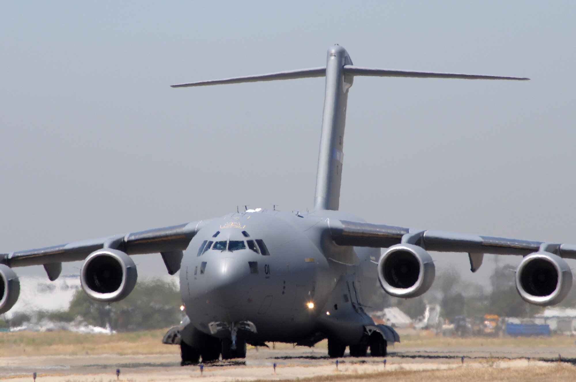 A C-17 Globemaster takes off from Long Beach Airport en route to Papa Air Base in Hungary, July 14. The plane is the first of three C-17 Globemaster IIIs to be acquired by the 12-nation Strategic Airlift Capability Program. The Hungarian air base is home to the SAC Program's multinational, operational-level unit, the Heavy Airlift Wing, which will officially be activated July 27. (Photo by Joe Juarez)