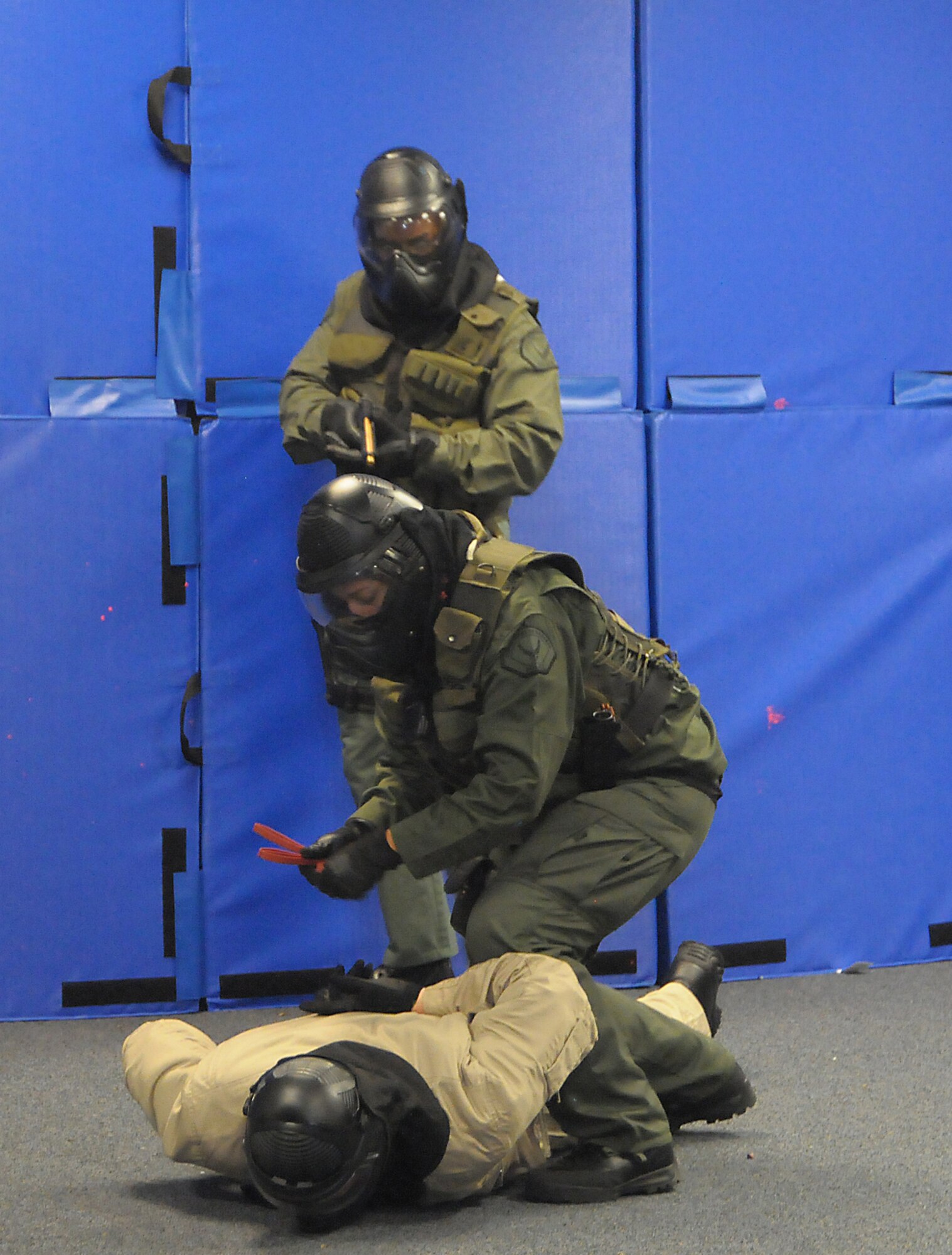 A DoD policeman subdues a perpetrator during the Blue Falcon Exercise, July 13. (Photo by Joe Juarez)