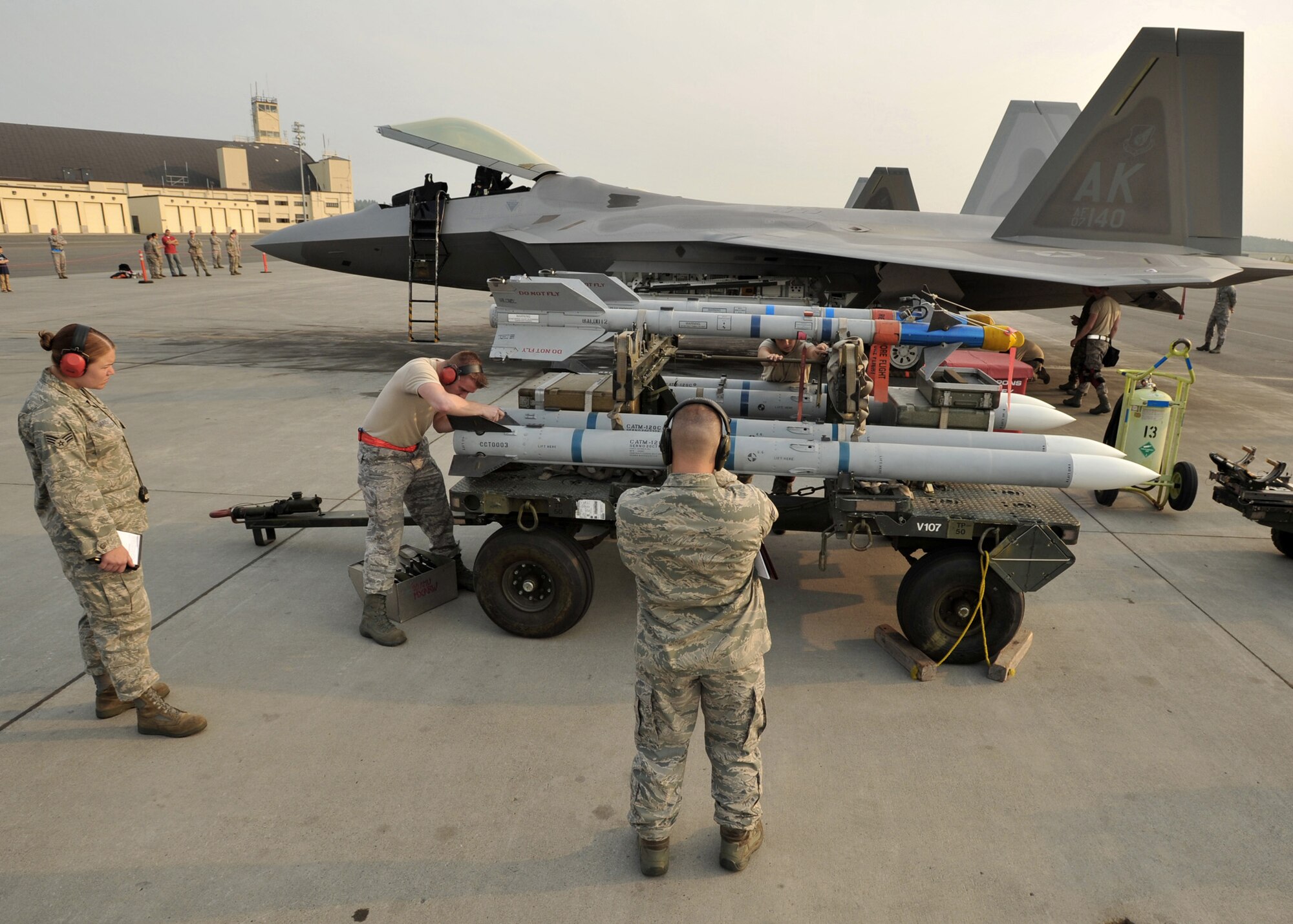 Airman 1st Class Daniel Kok installs a wing on a AIM-120 missile while evaluators Senior Airman Meghan Jarvis, 3rd Maintenance Operations Squadron, and Master Sgt. Francis Clement, 3rd Maintenance Group, look on July 10 at Elmendorf Air Force Base, Alaska. Airman Kok is assigned to the 3rd Aircraft Maintenance Squadron. (U.S. Air Force photo/Senior Airman Laura Turner)