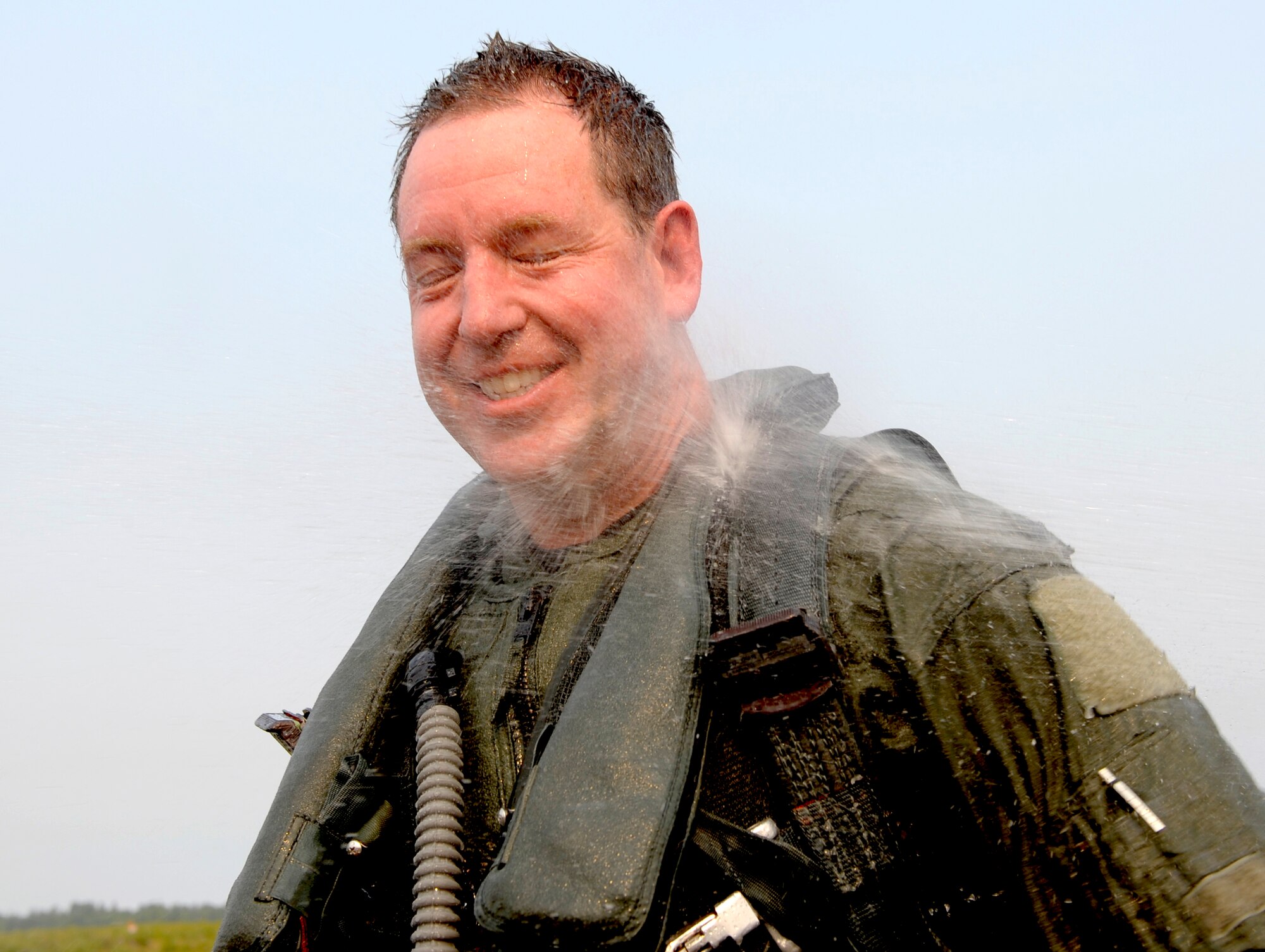ELMENDORF AIR FORCE BASE, Alaska -- Col. James Hecker is doused with water after his final flight here July 9. Hecker was the 3rd Operations Group commander. (U.S. Air Force photo/Master Sgt. Keith Brown)