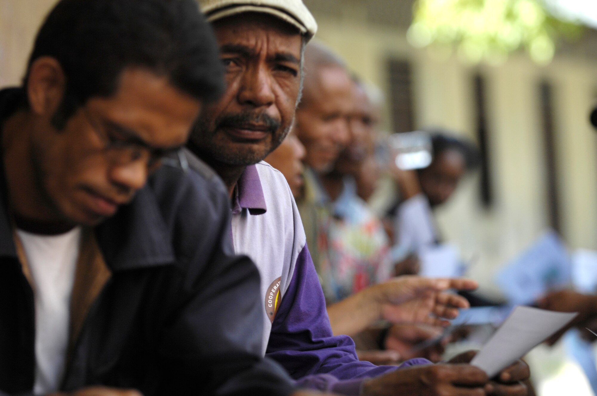 An East Timorese man waits outside a makeshift optometry office for a free exam at a clinic set up in Dili, Timor Leste, July 16. More than 300 people were seen on the first of four days at the clinic. East Timorese and U.S. officials set up the clinic as part of Operation Pacific Angel 2009, a Pacific Air Forces humanitarian assistance operation led by 13th Air Force at Hickam Air Force Base, Hawaii. (U.S. Air Force photo/Tech. Sgt. Cohen A. Young)   