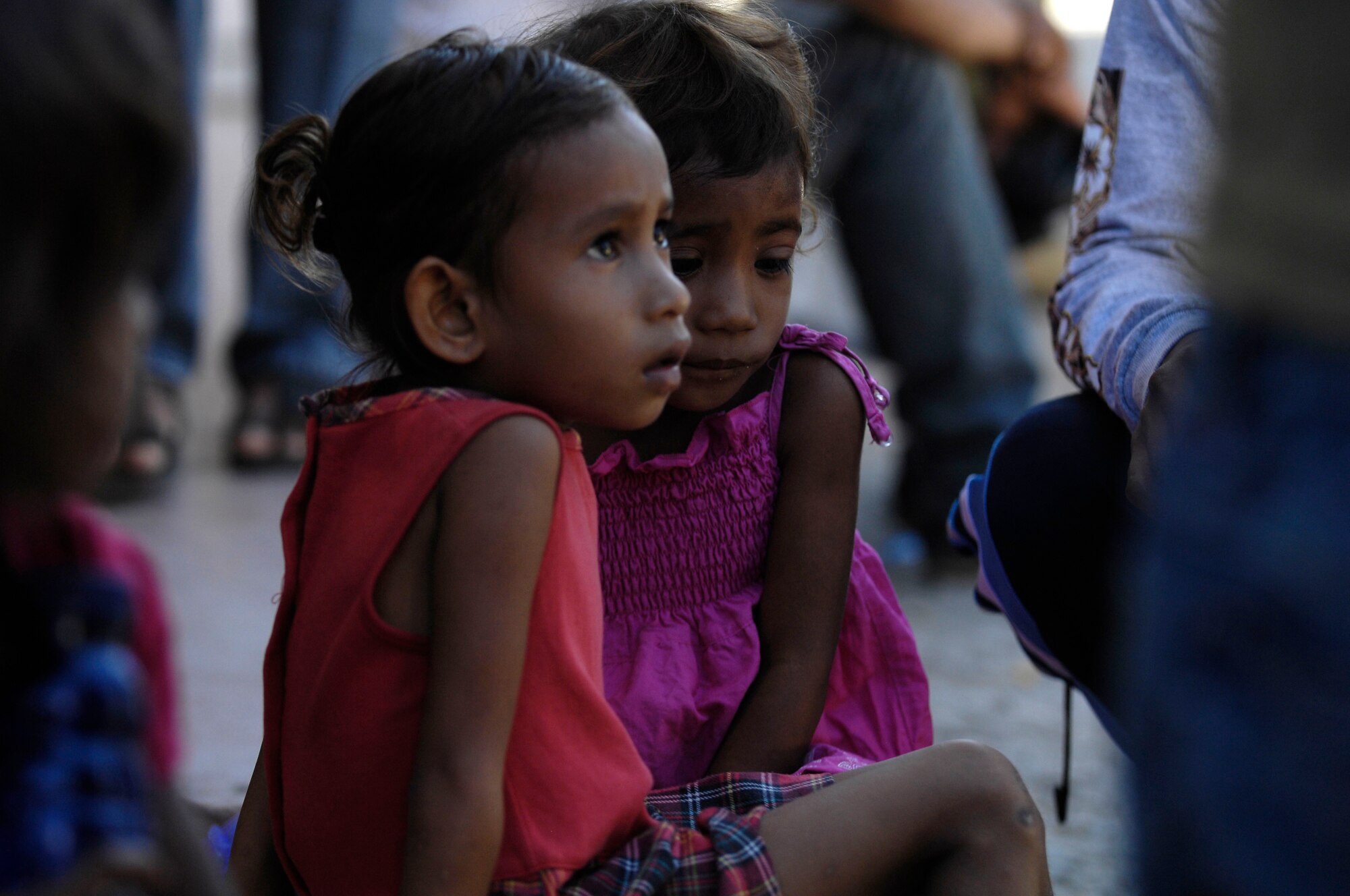 Two East Timorese girls wait to be seen by a U.S. Air Force family care physician while at a clinic in Dili, Timor Leste, July 16. More than 300 people were seen on the first of four days at the clinic. East Timorese and U.S. officials set up the clinic as part of Operation Pacific Angel 2009, a Pacific Air Forces humanitarian assistance operation led by 13th Air Force at Hickam Air Force Base, Hawaii. (U.S. Air Force photo/Tech. Sgt. Cohen A. Young)   