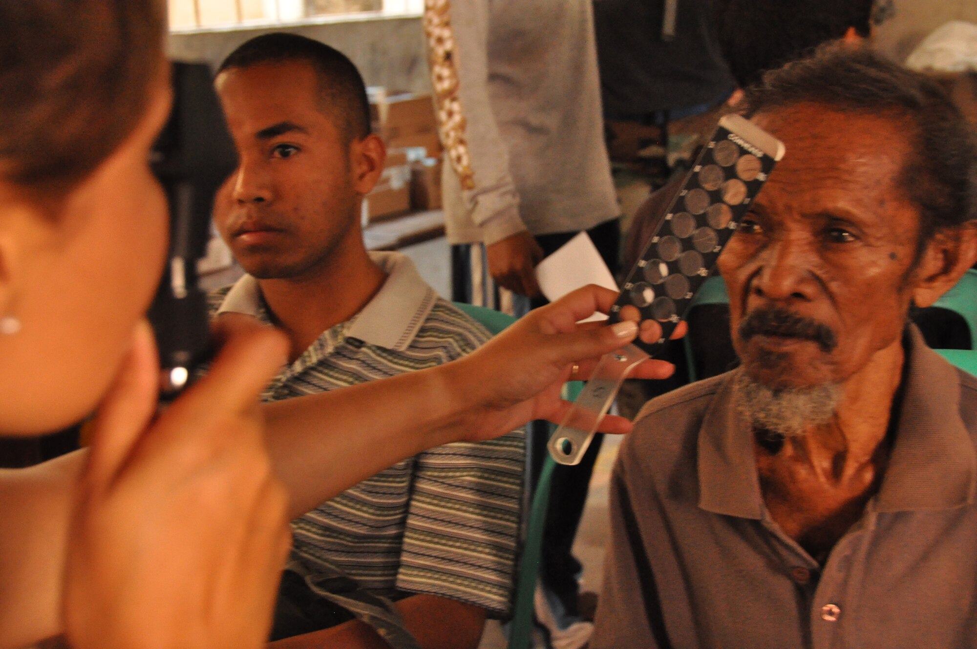 An East Timorese man has his eyes examined during inprocessing at a clinic in Dili, Timor Leste, July 16.  East Timorese and U.S. officials set up the clinic as part of Operation Pacific Angel 2009, a Pacific Air Forces humanitarian assistance operation led by 13th Air Force at Hickam Air Force Base, Hawaii. (U.S. Air Force photo/Tech. Sgt. Cohen A. Young)   