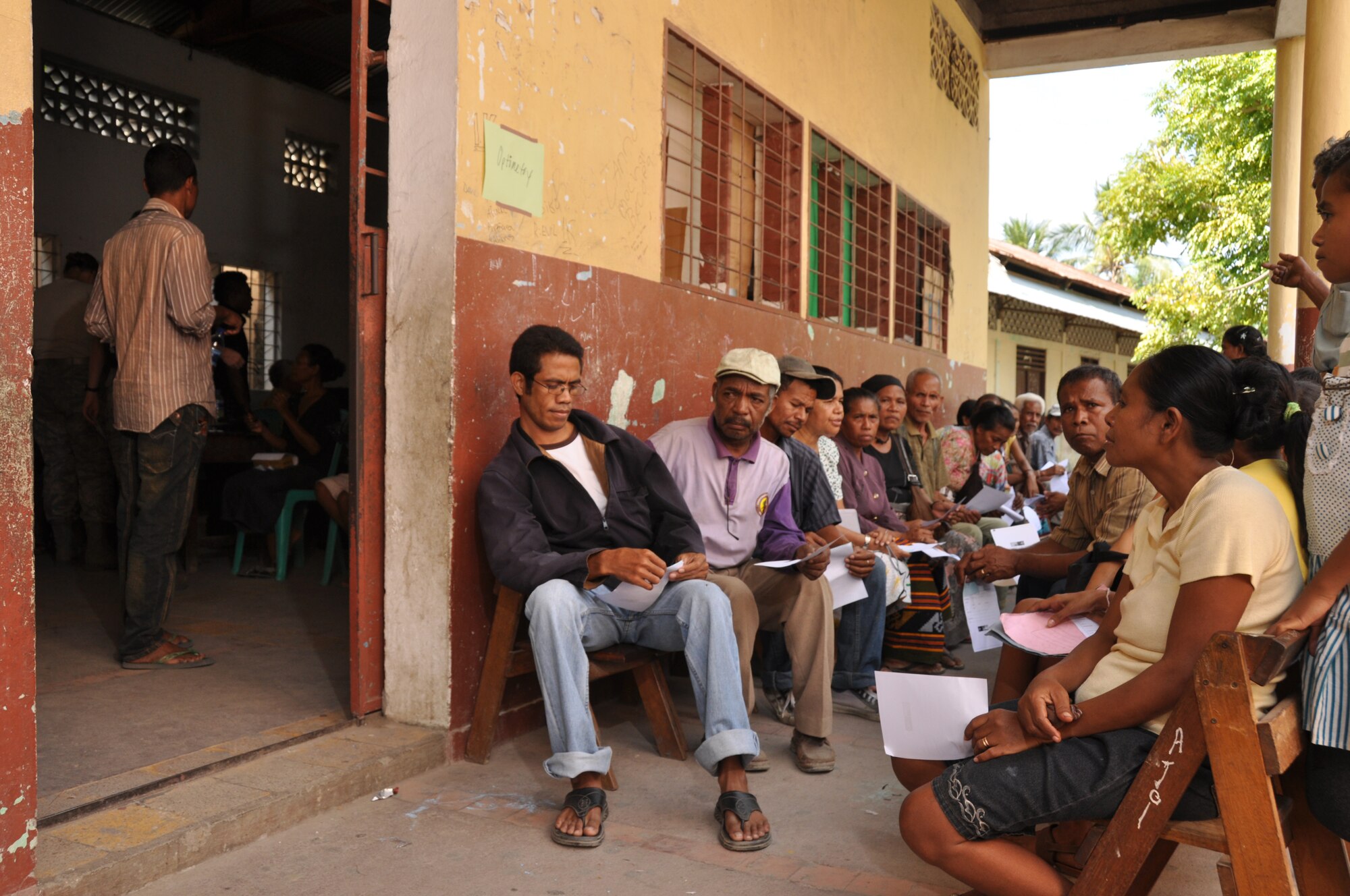 Local residents wait outside a makeshift optometry office for free exams at a clinic set up in Dili, Timor Leste, July 16.  East Timorese and U.S. officials set up the clinic as part of Operation Pacific Angel 2009, a Pacific Air Forces humanitarian assistance operation led by 13th Air Force at Hickam Air Force Base, Hawaii. (U.S. Air Force photo/Tech. Sgt. Cohen A. Young)   