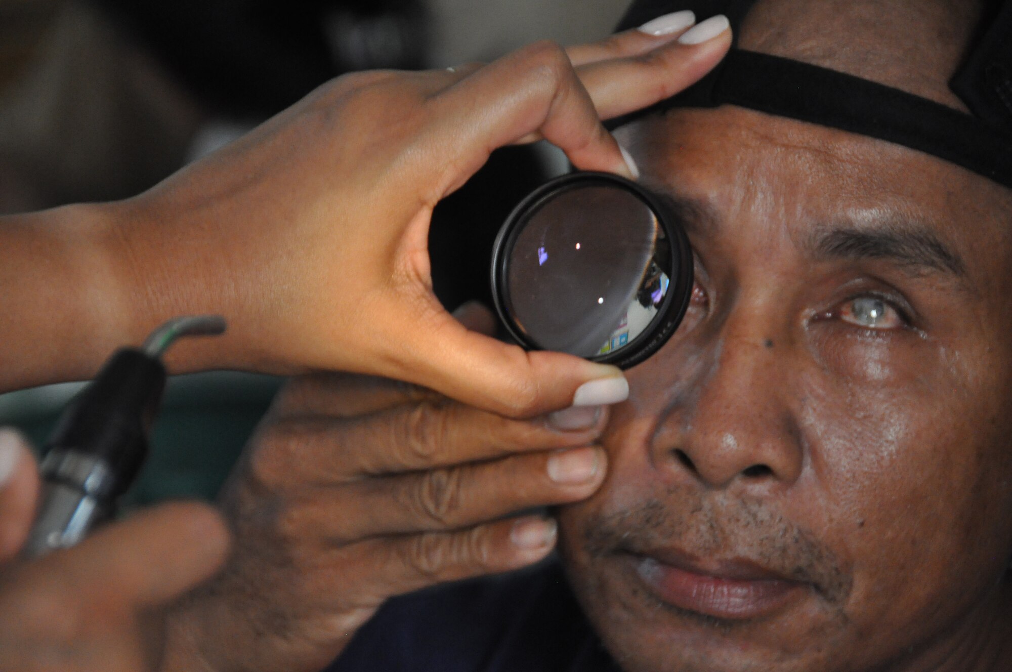An East Timorese man has his eye examined during inprocessing at a clinic in Dili, Timor Leste, July 16.  East Timorese and U.S. officials set up the clinic as part of Operation Pacific Angel 2009, a Pacific Air Forces humanitarian assistance operation led by 13th Air Force at Hickam Air Force Base, Hawaii. (U.S. Air Force photo/Tech. Sgt. Cohen A. Young)   