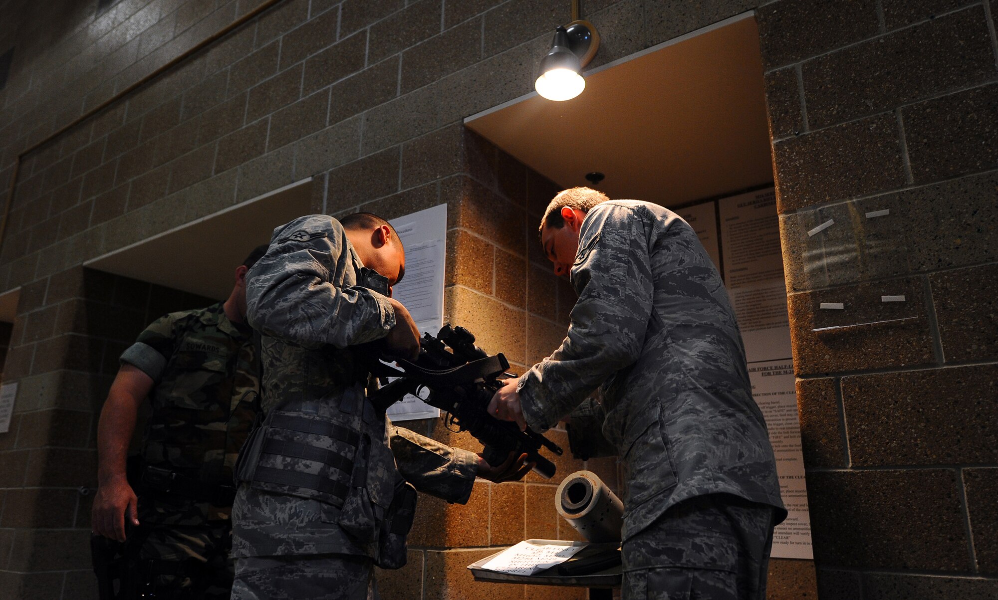 OFFUTT AIR FORCE BASE Neb. -- Airman Benjamin Chagoya, 55th Security Forces Squadron, clears an M-203 gernade launcher outside the 55th SFS armory here July 14. The armory maintains and issues a wide array of weaponry to security forces Airmen. U.S. Air Force Photo by Josh Plueger
