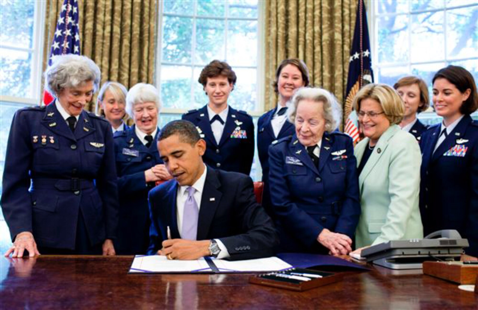 President Barack Obama signs S.614 in the Oval Office July 1 at the White House. The bill awards a Congressional Gold Medal to Women Airforce Service Pilots. The WASP program was established during World War II, and from 1942 to 1943, more than 1,000 women joined, flying 60 million miles of noncombat military missions. Of the women who received their wings as Women Airforce Service Pilots, approximately 300 are living today. (Official White House photo/Pete Souza)
