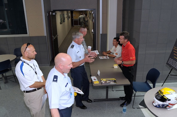 Maj. Gen. John Bordelon, NORAD-USNORTHCOM chief of staff, talks with Top Fuel driver Clay Millican July 13 at Building 2. Spencer Massey, another Top Fuel driver, is seated in the background. (Photo courtesy NORAD-USNORTHCOM)