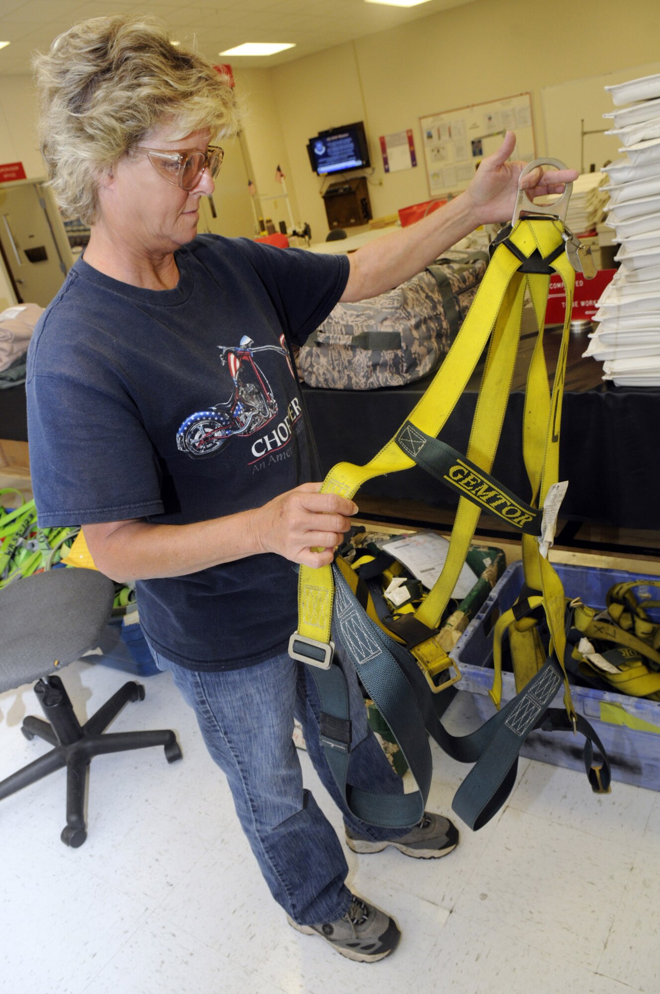 Alice Taylor, fabric worker, holds up a safety harnass. The fabric shop is responsible for maintenance and also making safety harnass that keep maintenance workers safe.  U. S. Air Force photo by Sue Sapp