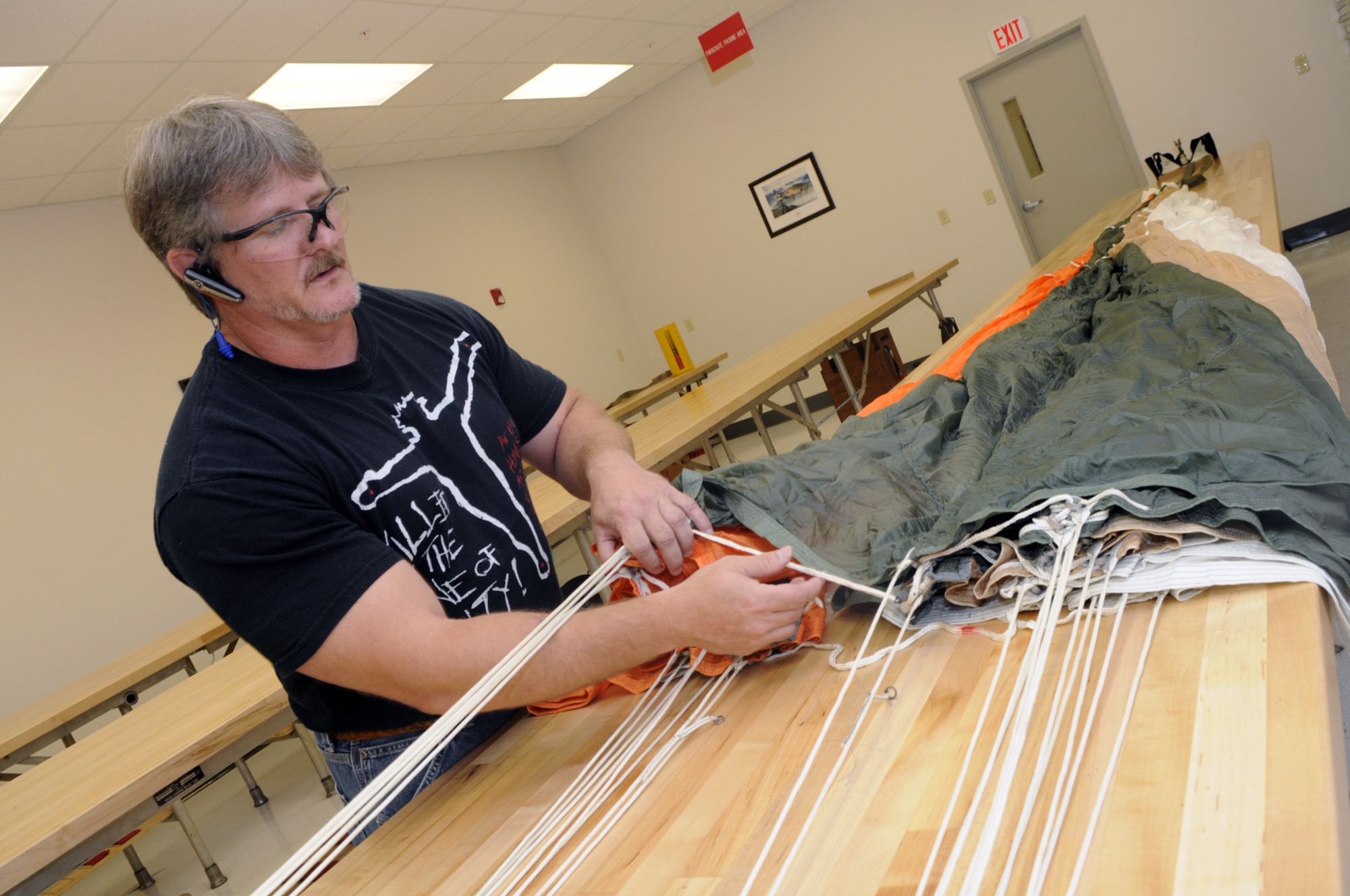 Mark Richey works on an F-15 ACES II parachute in the shop. U. S. Air Force photo by Sue Sapp