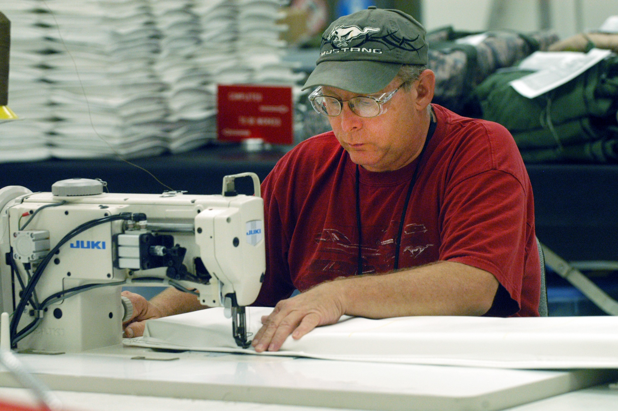 Sam Sellers, fabric worker, sews a C-5 heat exchanger blanket. U. S. Air Force photo by Sue Sapp