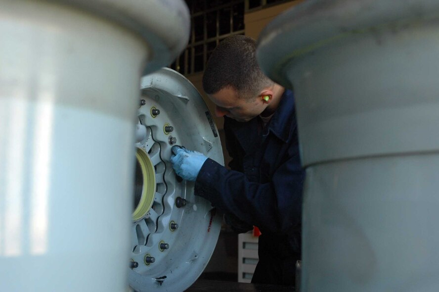 Airman 1st Class Mark Kuryn, 60th Maintenance Squadron, assembles halves of a wheel July 14, 2009, at Travis Air Force Base. Airman Kuryn is one of eight members of the Wheel and Tire Shop. (U.S. Air Force Base photo/Nick DeCicco)