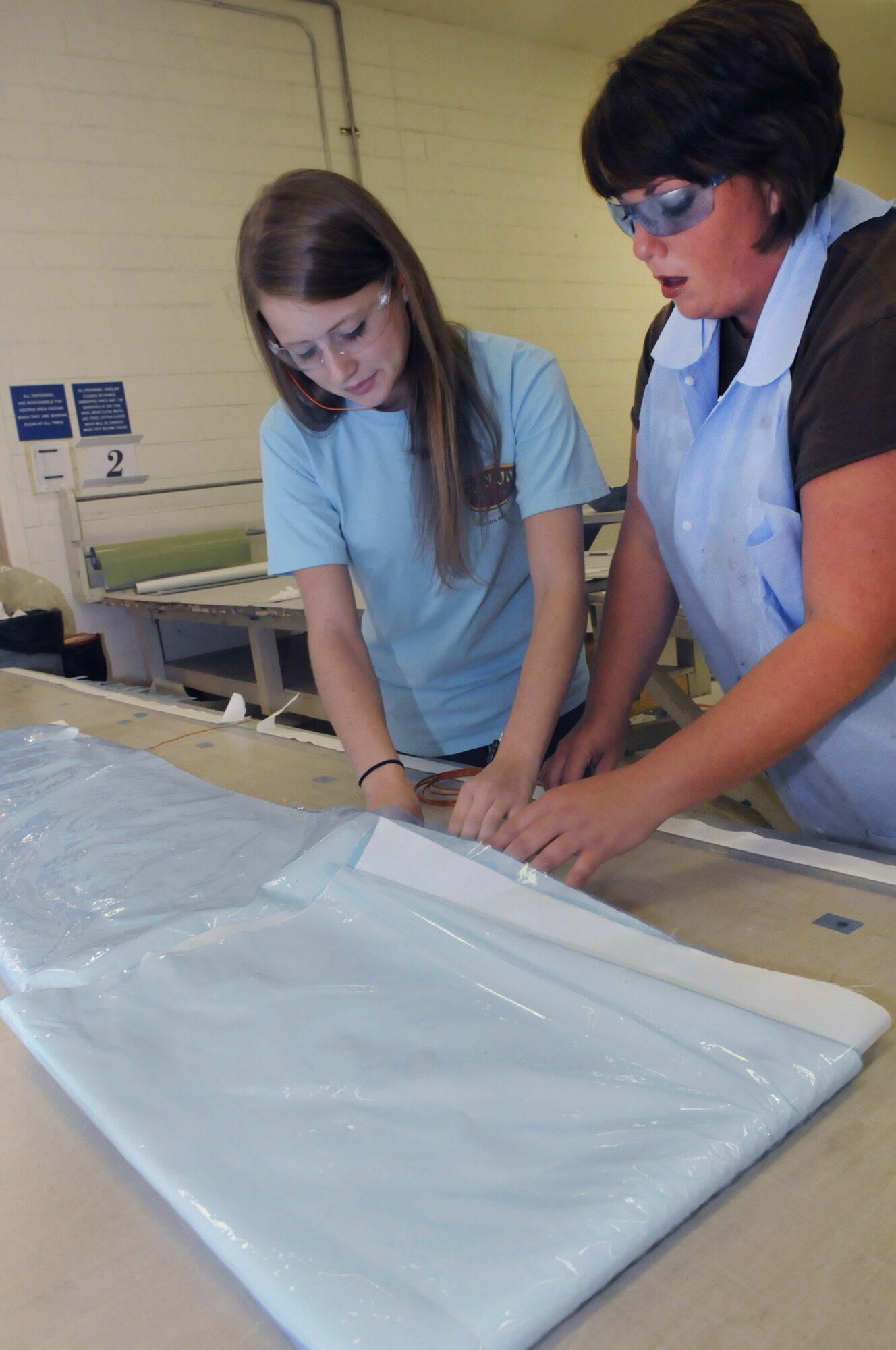 Lacey Roller, Central Georiga Technical College, works on C-5 panels with LaRae Humphries in the lay up room. U. S. Air Force photo by Sue Sapp