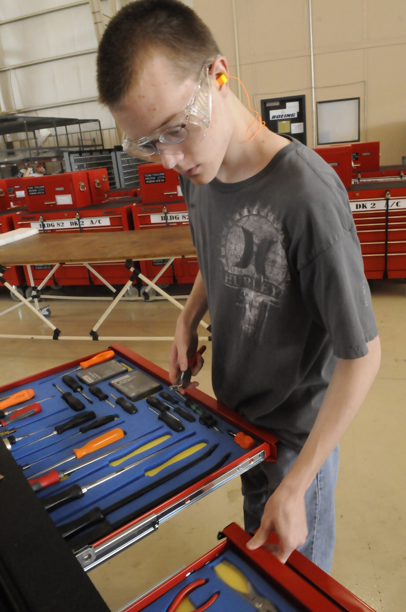 Brian O'Gorman, Warner Robins High School senior, returns tools to their places in a tool crib. The YAP students are taught proper tool control. U. S. Air Force photo by Sue Sapp