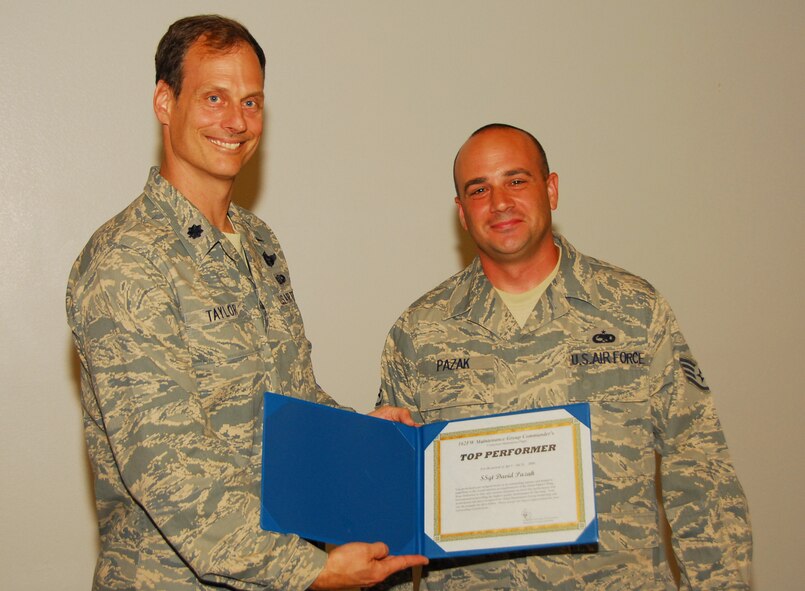 Staff Sgt. David Pazak from the Component Maintenance Flight receives a Top Performer award, the first in a new quarterly award program for maintainers who go beyond expectations for quality and safety. (Air National Guard photo by Master Sgt. Dave Neve)