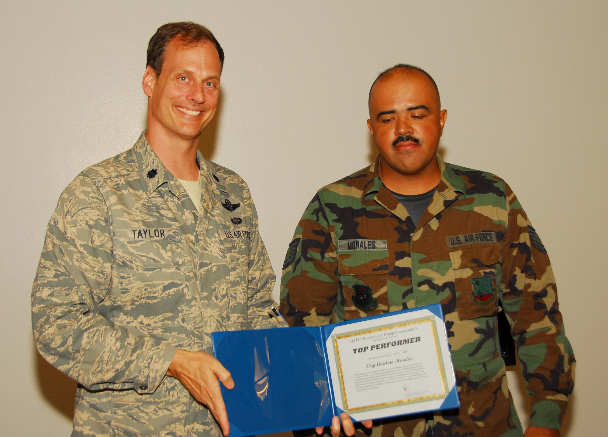 Staff Sgt. Antelmo Morales from the 148th Aircraft Maintenance Flight receives a Top Performer award, the first in a new quarterly award program for maintainers who go beyond expectations for quality and safety. (Air National Guard photo by Master Sgt. Dave Neve)