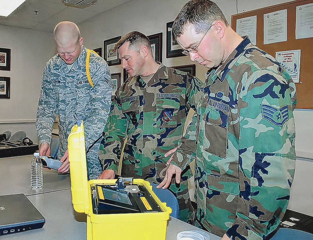 Airman 1st Class Jacob Crow, Senior Airman Adam Atchinson and Air Force Staff Sgt. Scott Sayer, all Class 09005, practice taking samples of non-evasive materials, April 10. During the Emergency Management Apprentice Course, Airmen are taught to plan for the worse and hope for the best when it comes to chemical, biological, radiological or nuclear situations. (U.S. Army photo)