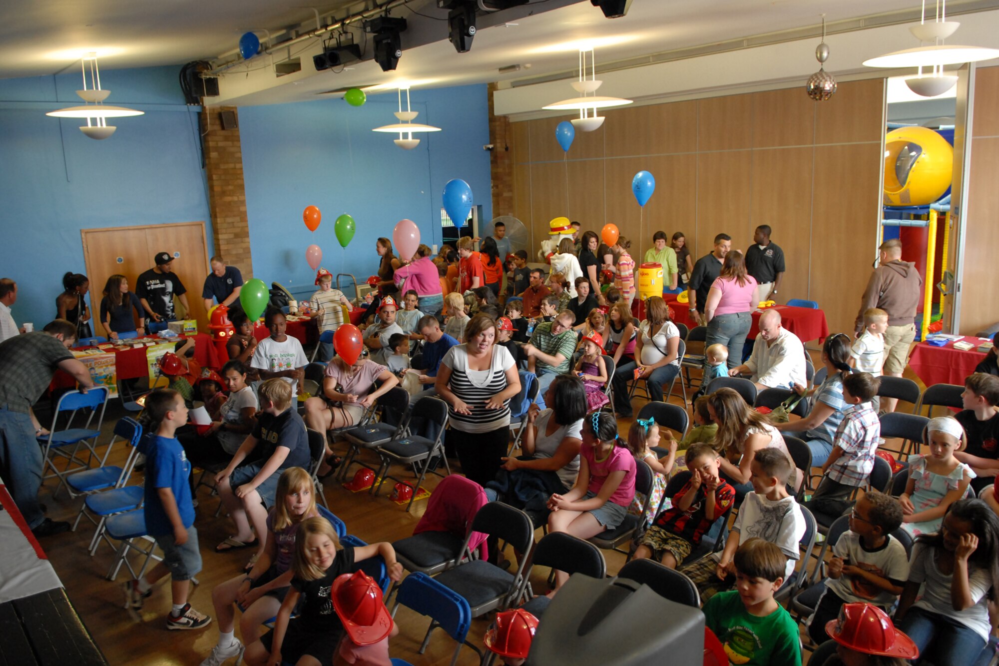 Dozens of children pack the Bob Hope Center at RAF Mildenhall to see award-winning children’s comedian Trevor Romain at the Bob Hope Community Center July 11.  The Comedian entertained and educated children about coping with parents deploying by using his own experiences growing up in South Africa and spending time in the South African Army.  (U.S. Air Force photo by Staff Sgt. Christopher L. Ingersoll)