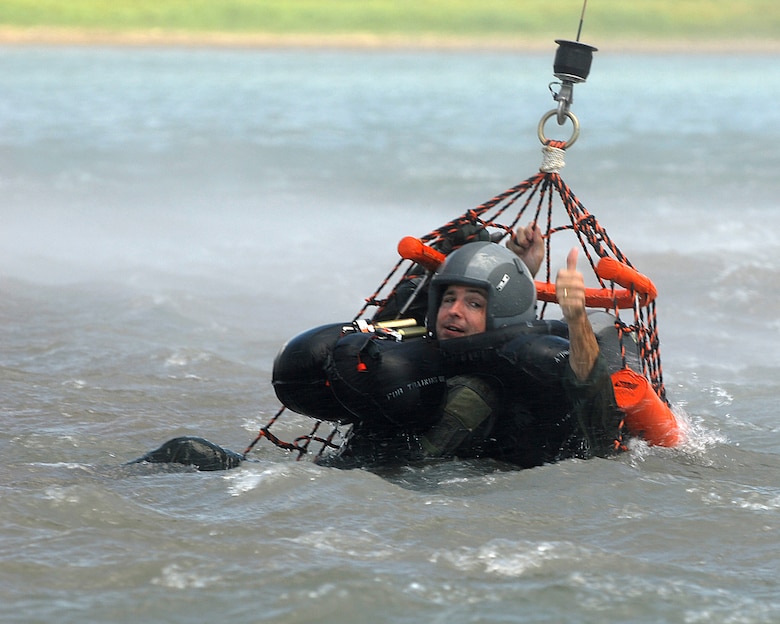 Maj Michael Meylor, an F-16 pilot assigned to the 149th Fighter Wing, Texas Air National Guard, Lackland Air Force Base, Texas, gives thumbs up for extraction to the crew of a UH-60 Black Hawk helicopter during a water survival training exercise at Canyon Lake, Texas, July 11, 2009.  (U.S. Air Force photo/Master Sgt. Robert Shelley)