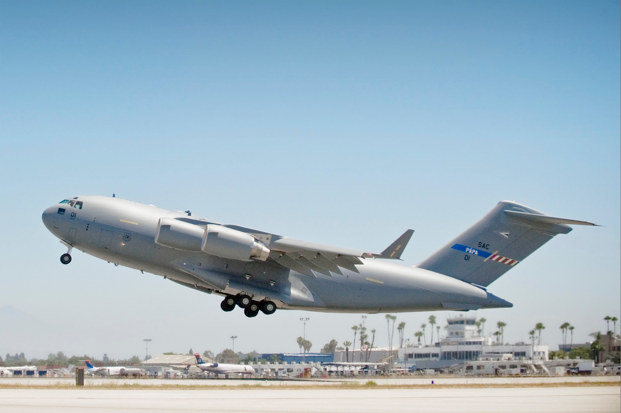 SAC 01 takes off beginning its 5,300-nautical-mile maiden flight July 14 from Long Beach, Calif., to Papa Air Base, Hungary. The aircraft is the first of three C-17 Globemaster IIIs to be acquired by the 12-nation Strategic Airlift Capability Program. The Hungarian air base is home to the SAC Program's multinational, operational-level unit, the Heavy Airlift Wing, which will officially be activated July 27. (Courtesy photo) 
