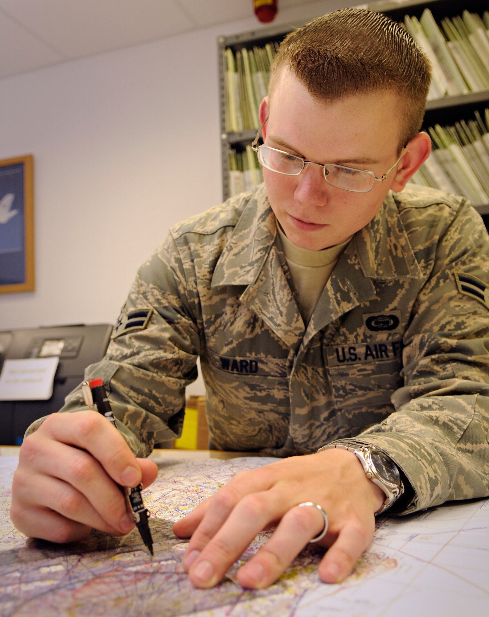 SPANGDAHLEM AIR BASE, Germany – Airman 1st Class Aric Ward, 52nd Operations Support Squadron targeteer, plots threats for an ingress route on a map in the intelligence flight of Spangdahlem Air Base’s 52nd OSS July 14. (U.S. Air Force photo by Senior Airman Benjamin Wilson)