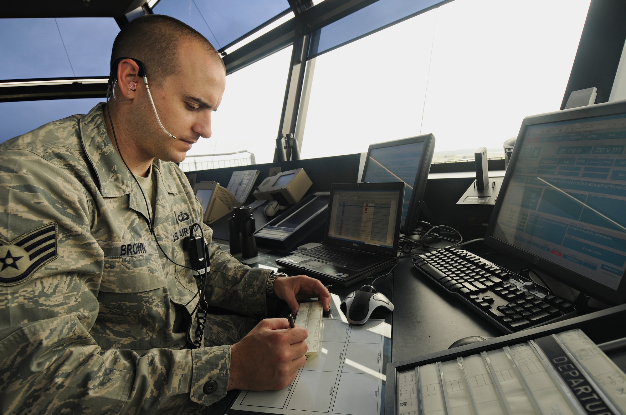 SPANGDAHLEM AIR BASE, Germany – Staff Sgt. James Brown, 52nd Operations Support Squadron air traffic controller, checks the computer in Spangdahlem Air Base’s air traffic control tower and coordinates air traffic with American and German agencies July 14. Airmen in the airfield operations flight are responsible for the airfield environment including oversight of Spangdahlem’s runway, parallel taxiway and six operational ramps, totaling more than 7 million square feet of airfield pavement. (U.S. Air Force photo by Senior Airman Benjamin Wilson)
