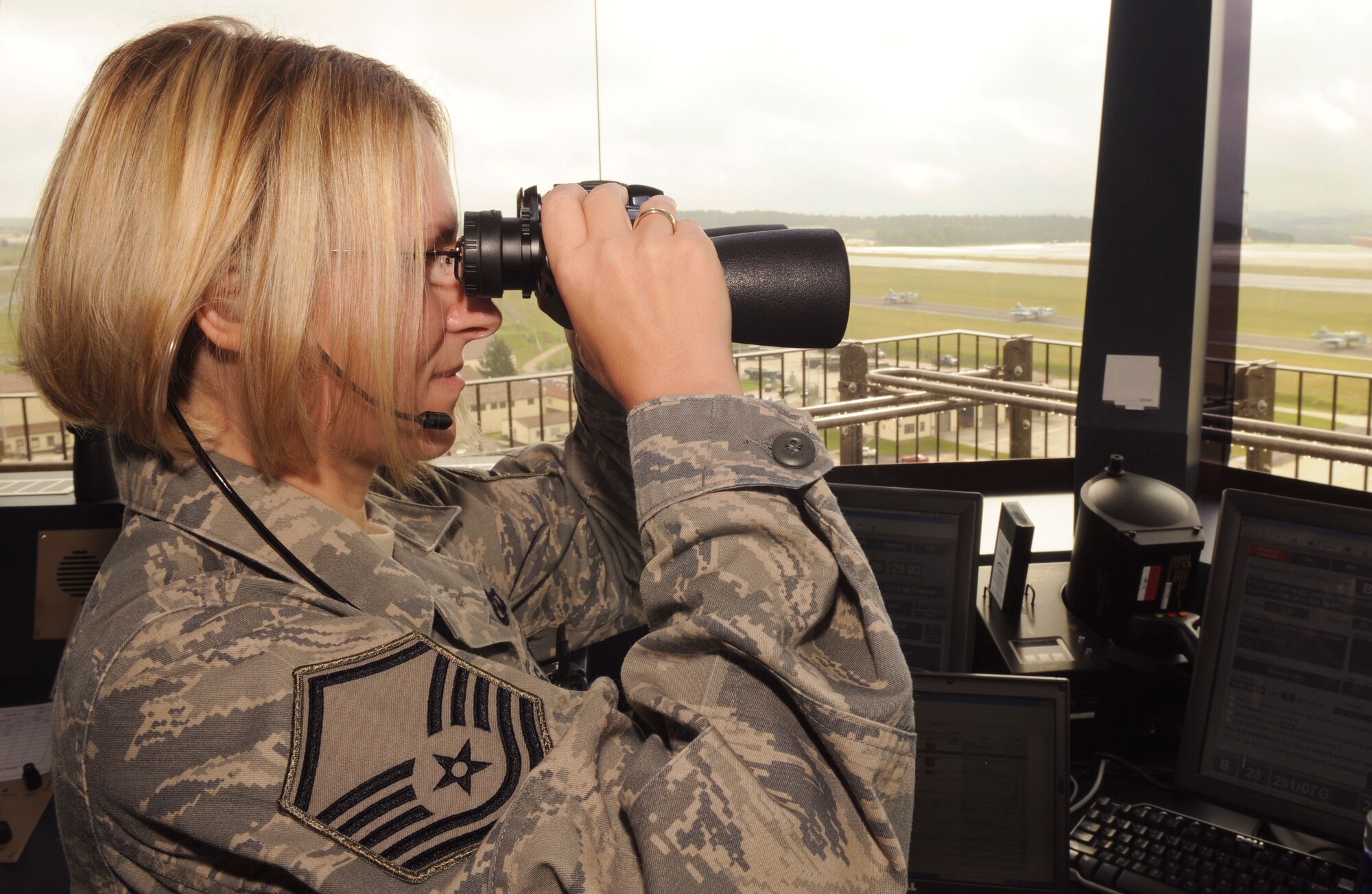 SPANGDAHLEM AIR BASE, Germany – Master Sgt. Tammy Kinder-Tims, 52nd Operations Support Squadron assistant tower chief controller, peers through her binoculars as A-10 Thunderbolt IIs taxi onto the Spangdahlem Air Base runway July 14. Airmen in the airfield operations flight are responsible for the airfield environment including oversight of Spangdahlem’s runway, parallel taxiway and six operational ramps, totaling more than 7 million square feet of airfield pavement. (U.S. Air Force photo by Senior Airman Benjamin Wilson)