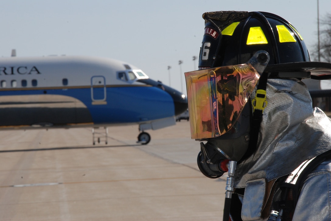 A firefighter looks over a 932nd Airlift Wing C-9C aircraft during training at Scott Air Force Base.  Firefighters stay busy keeping their skills proficient each drill weekend at the Air Force Reserve Command unit near Belleville, Ill.  (U.S. Air Force photo/Maj. Stan Paregien)