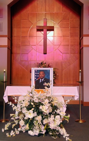 A memorial for Master Sgt. Jermode Pharr is displayed during a ceremony in the base chapel here July 8. Family, friends and comrades from across the base met at the chapel in remembrance of Sergeant Pharr and to mourn the loss of a faithful Airman. (U.S. Air Force photo/Staff Sgt. Daniel Bowles)