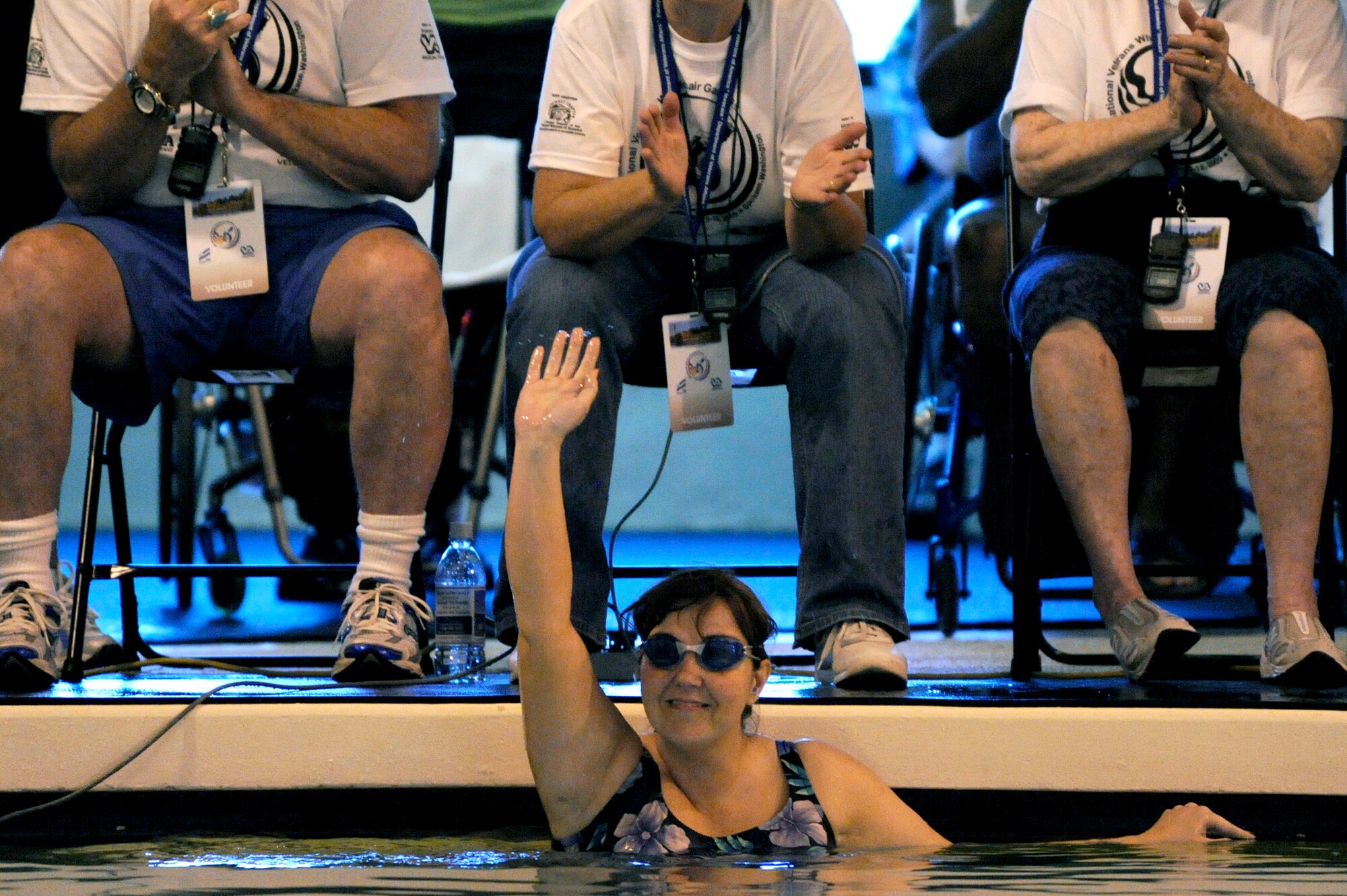 Terri Fuda waves to the crowd as she competes in the swimming competition held at the Whitworth University swimming pool during the 29th National Veterans Wheelchair Games July 15 in Spokane, Wash. Ms. Fuda is an Air Force veteran from Gillespie, Ill. (U.S. Air Force photo/Staff Sgt. Desiree N. Palacios)