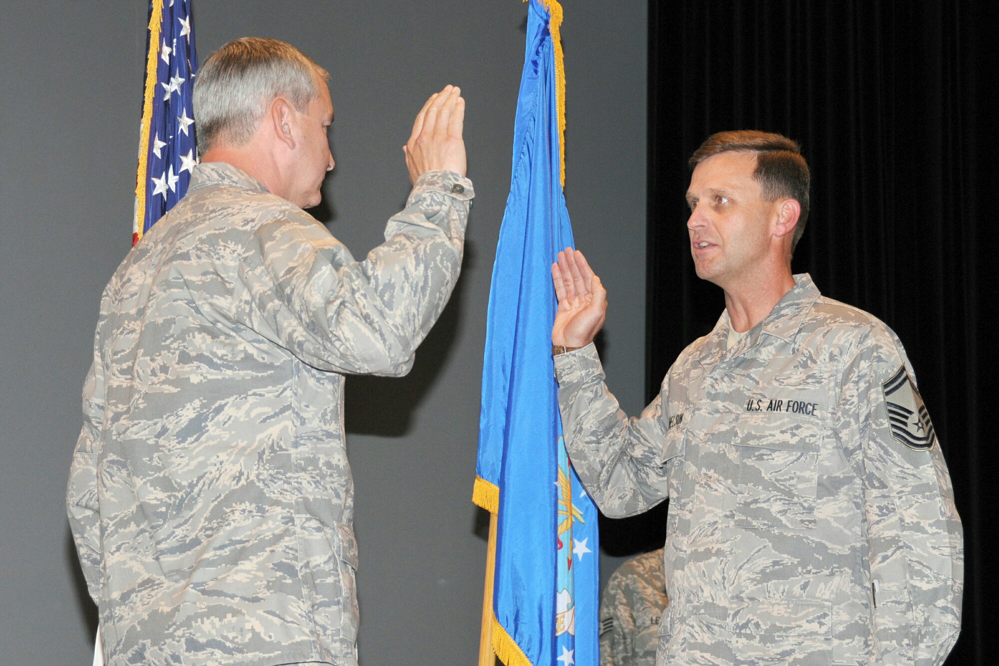 Col. Fritz Linsenmeyer, commander, 916th Air Refueling Wing, adminsters the oath of office to the new command chief, Chief Master Sgt. Gregory A. Nelson during commander's call July 11, at Seymour Johnson AFB, N.C.  (Photo by TSgt. Gillian M. Albro, 916th ARW/PA)