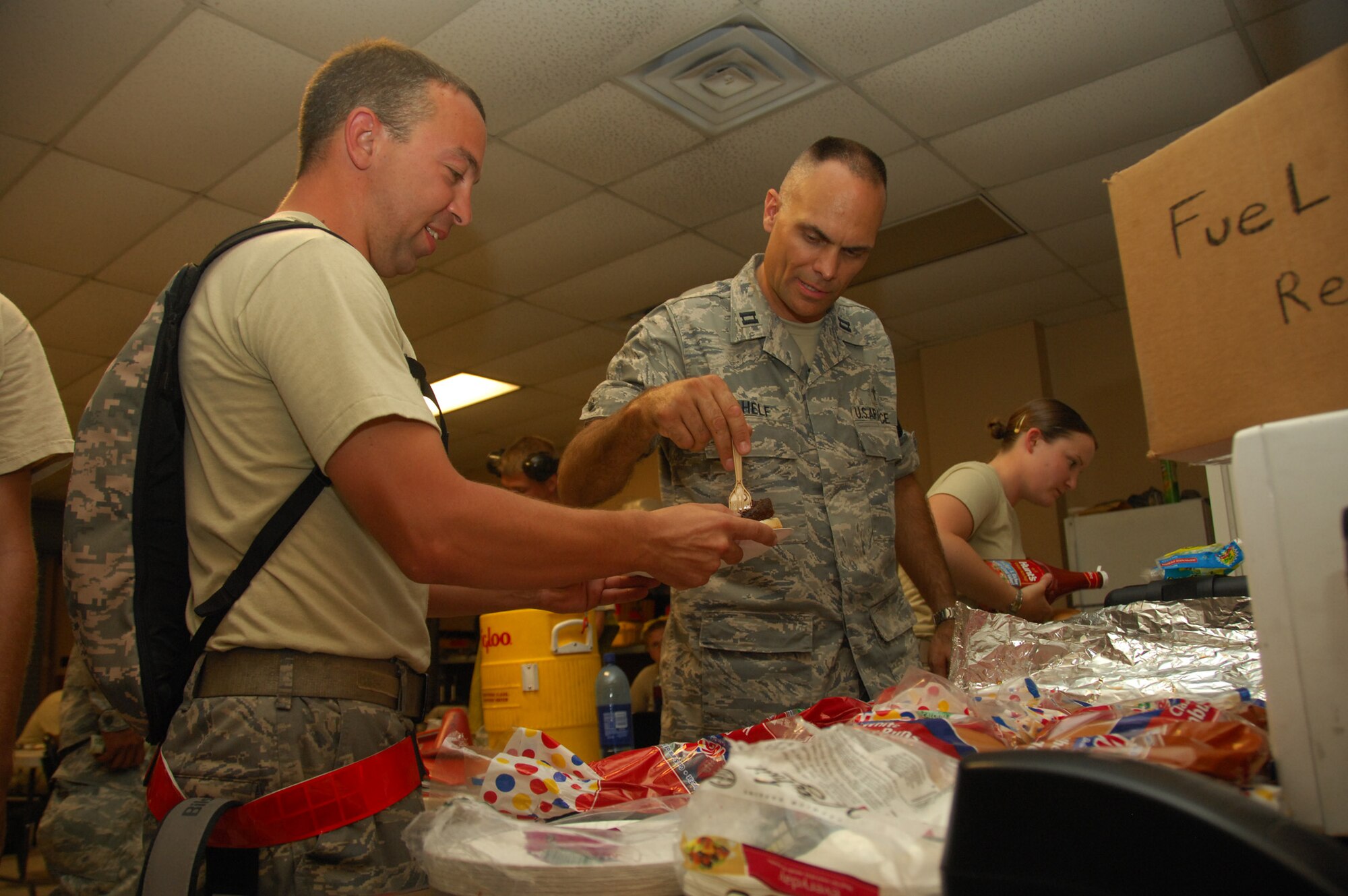 NELLIS AIR FORCE BASE, Nev. -- Red Flag Chaplain (Capt.) Kevin Chelf serves a hamburger to Staff Sgt. William Reeder, 20th Maintenance Group from Shaw Air Force Base, S.C. "It's really a chance to get out and put eyes on people," Chaplain Chelf said. "Our hope and prayer is that they remember the chaplain is here if they need him." Red Flag is an exercise that provides young Airmen - especially pilots - the opportunity to experience a combat environment.(U.S. Air Force photo/2nd Lt. Emily Chilson)