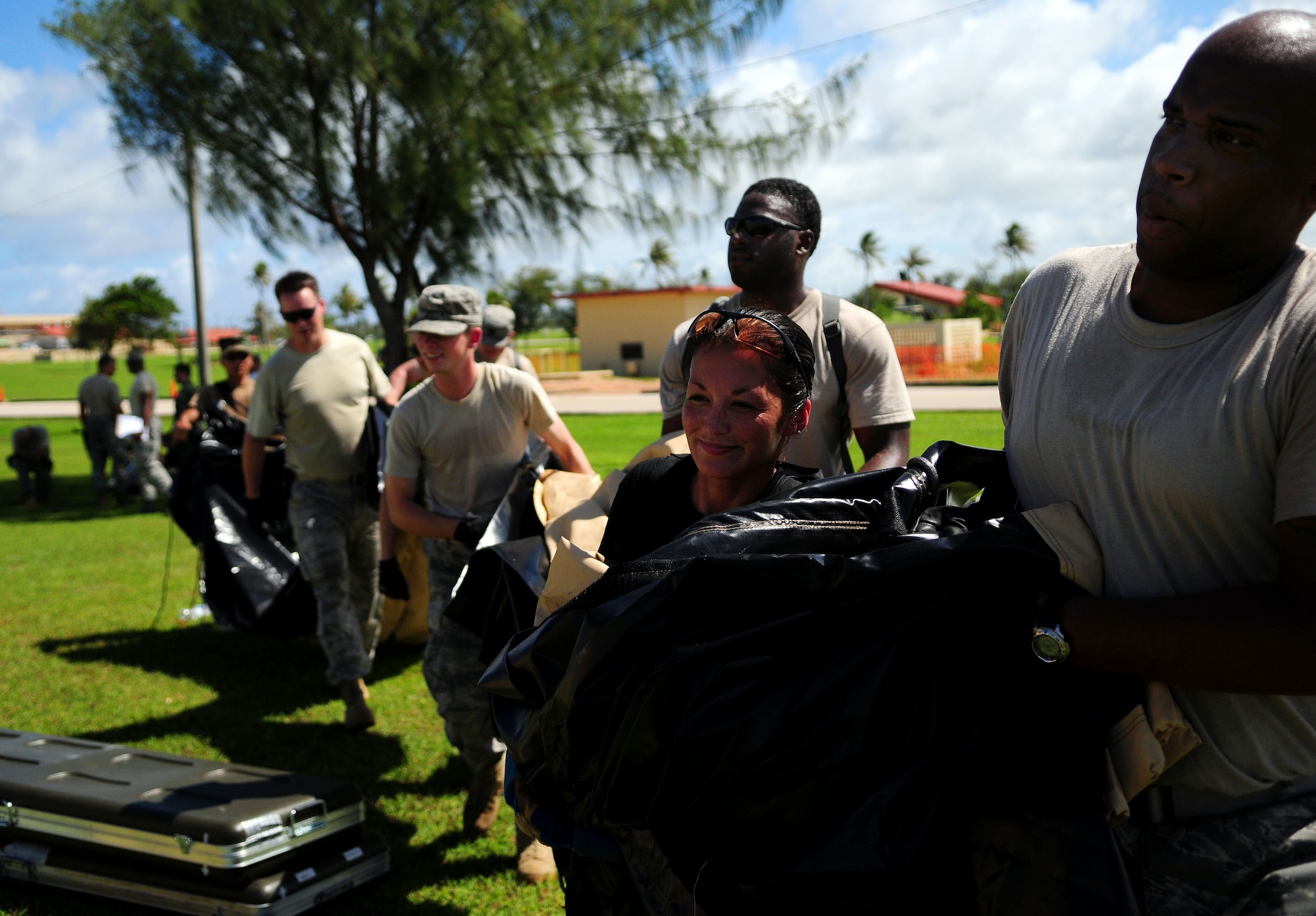 ANDERSEN AIR FORCE BASE, Guam - The 36th Medical Group and the 36th Contingency Response Group work together to put the last piece of the tents together during a simulated exercise for the Humanitarian Assistance Rapid Response Team here July 15. The HARRT is equipped to operate in an austere permissive environment during phase III of disaster relief operations supporting 350 to 500 patients per day and can be fully operational within six hours of arrival at the disaster site. (U.S. Air Force photo by Airman 1st Class Courtney Witt)