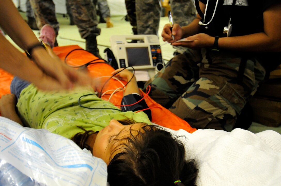 ANDERSEN AIR FORCE BASE, Guam - Mass casualty victim Alessia Castro is being restated by 36th Medical Group physicians during a simulated exercise for the Humanitarian Assistance Rapid Response Team here July 15.  The 36th Medical Group will provide the medical elements of medical logistics, bioenvironmental equipment support, emergency and resuscitative care, ambulatory care, mental health care, limited laboratory and pharmacy, public health, bioenvironmental engineering and flight medicine support. (U.S. Air Force photo by Airman 1st Class Courtney Witt) 