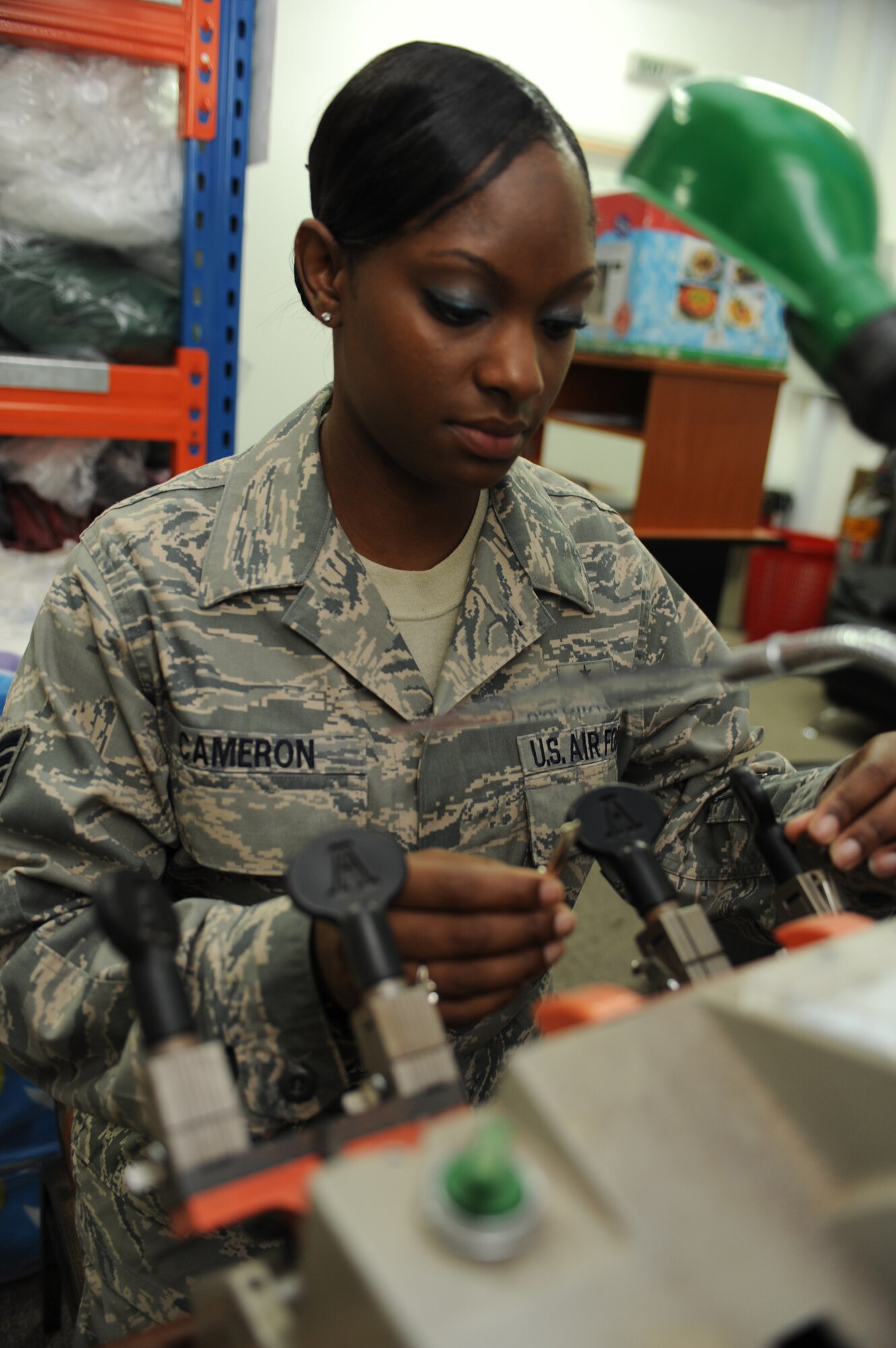 SOUTHWEST ASIA - Staff Sgt. Segonia Cameron, 380th Expeditionary Force Support Squadron,inspects a key to ensure proper reproduction July 15. Sergeant Cameron is working as a lodging technician while deployed from Barksdale Air Force
Base, La., and hails from Shreveport, La. (U.S. Air Force photo/Tech. Sgt. Charles Larkin Sr) 
