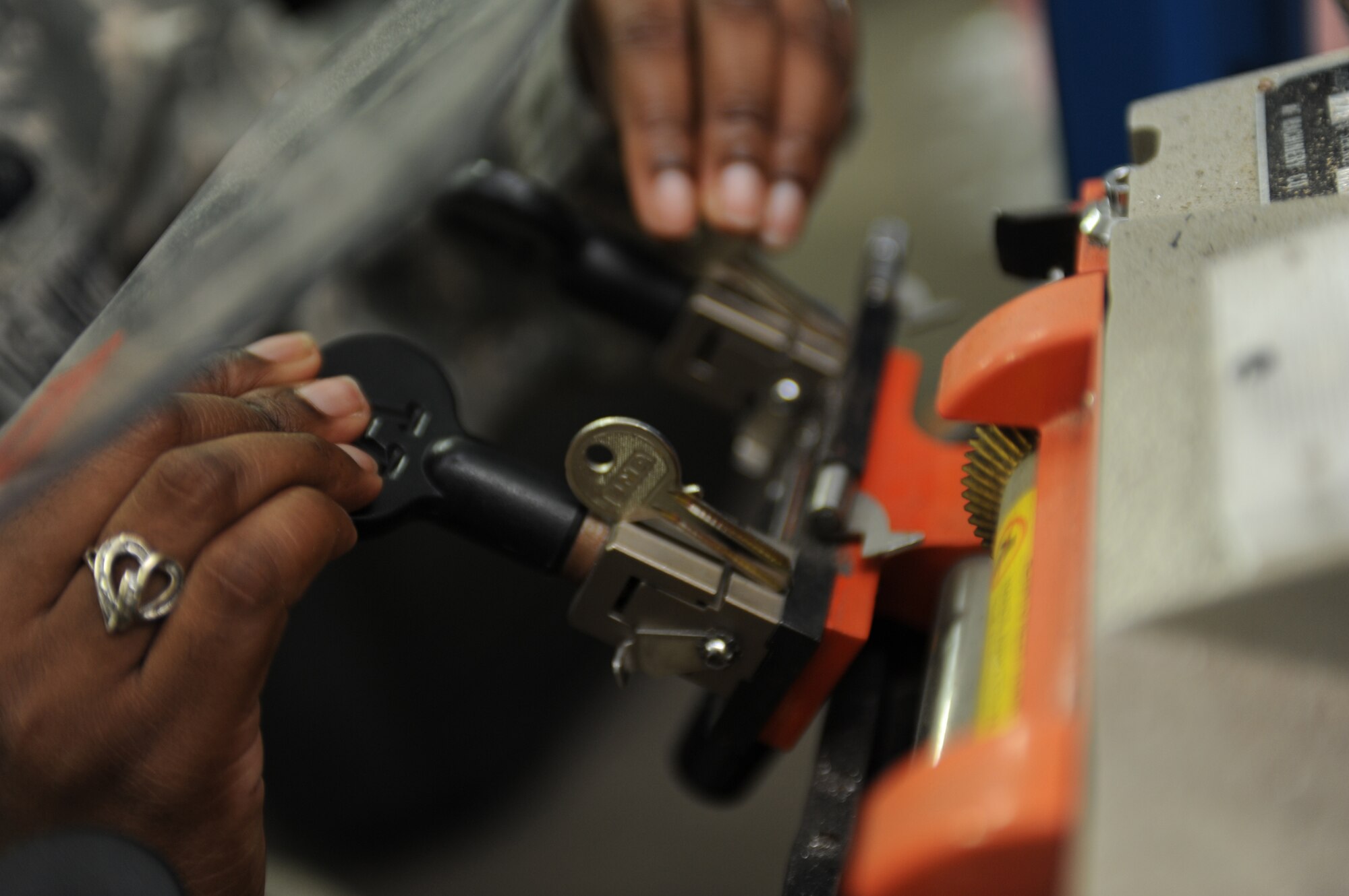 SOUTHWEST ASIA - Staff Sgt. Segonia Cameron, 380th Expeditionary Force Support Squadron,loosens the vices on a key cutting machine to insert the master key for reproduction July 15. Sergeant Cameron is working as a lodging technician
while deployed from Barksdale Air Force Base, La., and hails from Shreveport, La.(U.S. Air Force photo/Tech. Sgt. Charles Larkin Sr)
