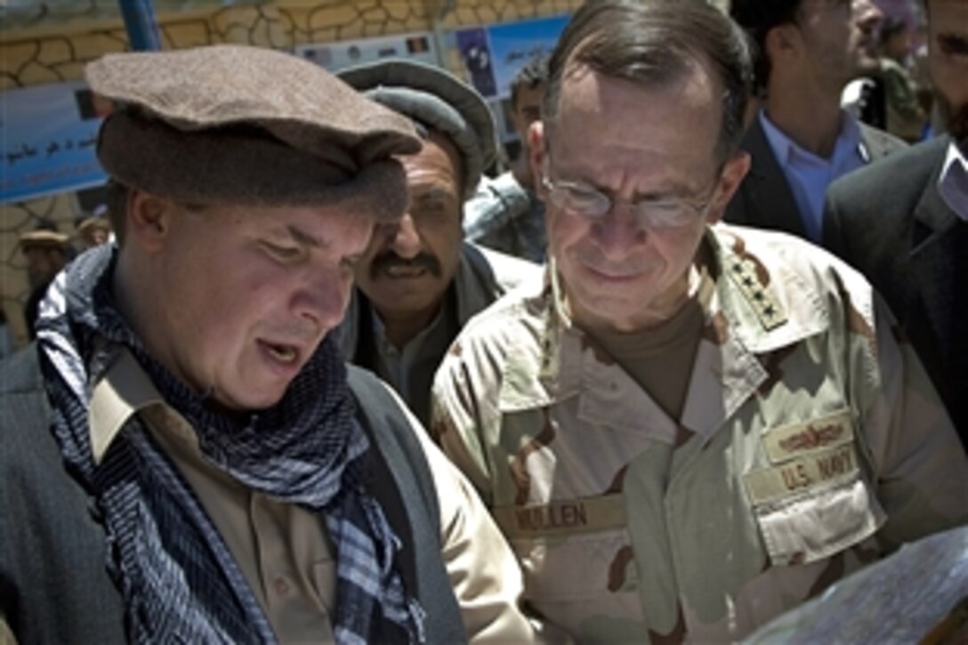 Author Greg Mortenson shows the locations of future village schools to U.S. Navy Adm. Mike Mullen, chairman of the Joint Chiefs of Staff, at the opening of Pushghar Village Girls School 60 miles north of Kabul in Panjshir Valley, Afghanistan, July 15, 2009. Mortenson, who wrote "Three Cups of Tea," built the new school to promote community education, especially for girls, in remote regions of Pakistan and Afghanistan. 
