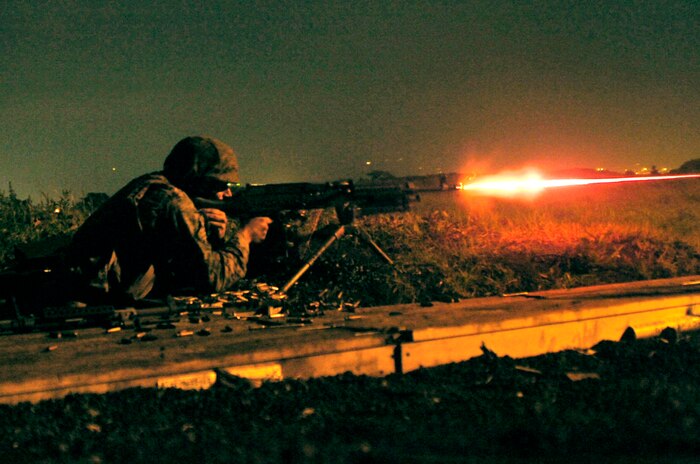 Cpl. Robert Giuliani, a Combat Logistics Company 36 Marine, fires tracer rounds from a 240G medium machine gun during the night fire portion of Exercise Dragon Fire 2009.