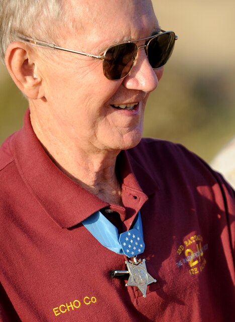 Retired Maj. Gen. James E. Livingston talks to members of Company E, 2nd Battalion, 4th Marine Regiment, during a field mess night here July 16. Livingston served as the E Co. commander in 1968 during the Vietnam War. There he earned the Medal of Honor and many other decorations for heroic actions in combat.