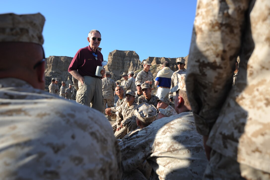 Retired Maj. Gen. James E. Livingston talks to members of Company E, 2nd Battalion, 4th Marine Regiment, during a field mess night here July 16. Livingston served as the E Co. commander in 1968 during the Vietnam War. There he earned the Medal of Honor and many other decorations for heroic actions in combat.