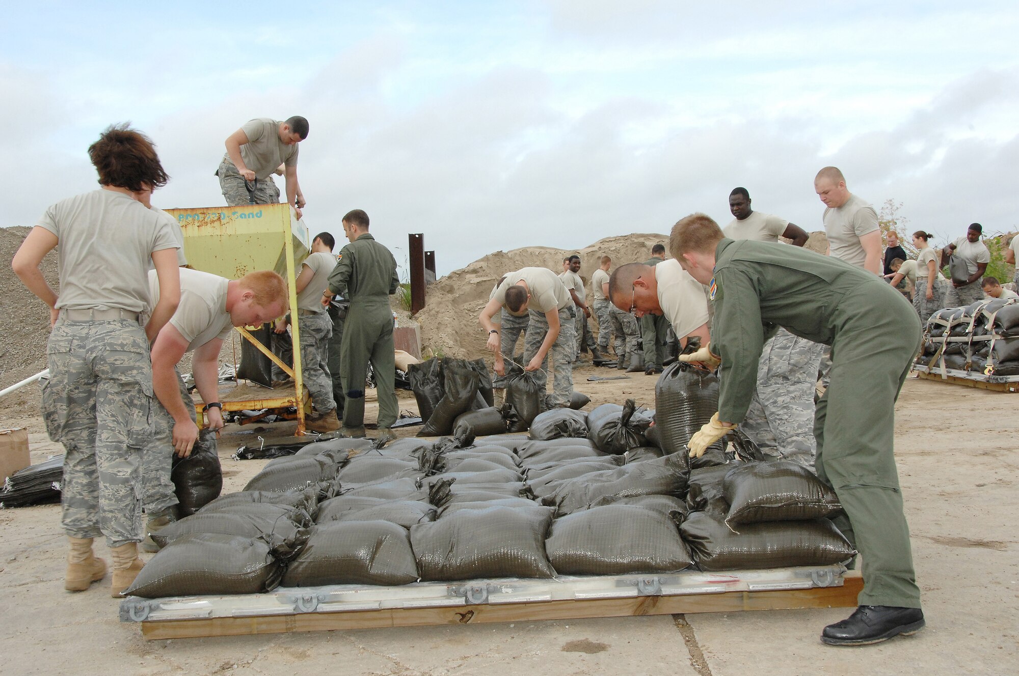 OFFUTT AIR FORCE BASE, Neb. -- Members of the Offutt community place sand bags on a palette to be transported to the 55th Wing Parking lot where Safety Training was being conducted.AF Photo by Dana Heard
