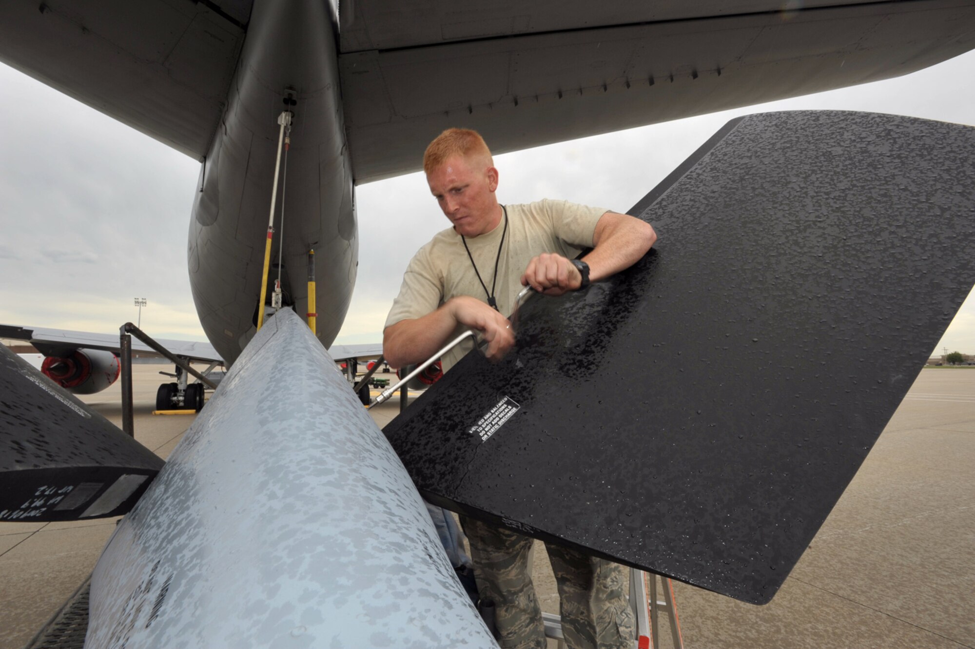 Rain pours down on Senior Airman Chris Hughes as he reattaches a panel to the boom pod of a KC-135 Stratotanker Friday at McConnell Air Force Base, Kan. Airman Hughes is assigned to the 22nd Air Refueling Wing, the 931st Air Refueling Group's active-duty host unit at McConnell. Reservists from the 931st and active-duty Airmen from the 22nd, including Airman Hughes, are scheduled to compete at Air Mobility Command's annual readiness competition for the first time. (U.S. Air Force photo/Tech. Sgt. Jason Schaap)