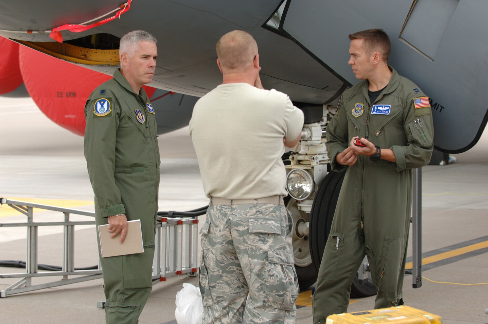 Lt. Col. John Wood (on left) talks Friday with Master Sgt. Al Ryder and Capt. Jeff Taylor on the flightline of McConnell Air Force Base, Kan. The three are part of team scheduled to compete at Air Mobility Command Rodeo 2009, a world-wide readiness competition at McChord AFB, Wash., from July 19 to July 25. Colonel Wood is a Reserve KC-135 Stratotanker pilot assigned to the 18th Air Refueling Squadron, the flying unit of the 931st Air Refueling Group at McConnell. Sergeant Ryder, also a 931st Reservist, is leading the KC-135 maintenance team headed to the Rodeo. Captain Taylor is assigned to the 22nd Air Refueling Wing, the 931st's active-duty host unit at McConnell. (U.S. Air Force photo/Tech. Sgt. Jason Schaap)
