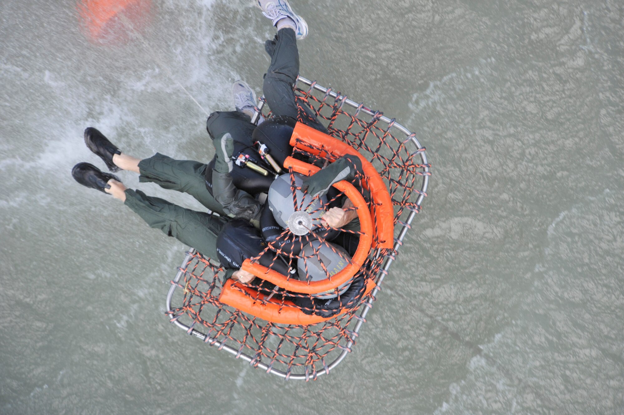 Two pilots from the Texas Air National Guard's 149th Fighter Wing in San Antonio are raised out of the water during refresher aircrew water survival training at Canyon Lake near San Antonio. Army National Guard UH-60 crews from the 149th Aviation Regiment in San Antonio provided airlift support. The refresher training is mandatory for all aircrew members. (U.S. Air Force photo/Master Sgt Jack Braden)
