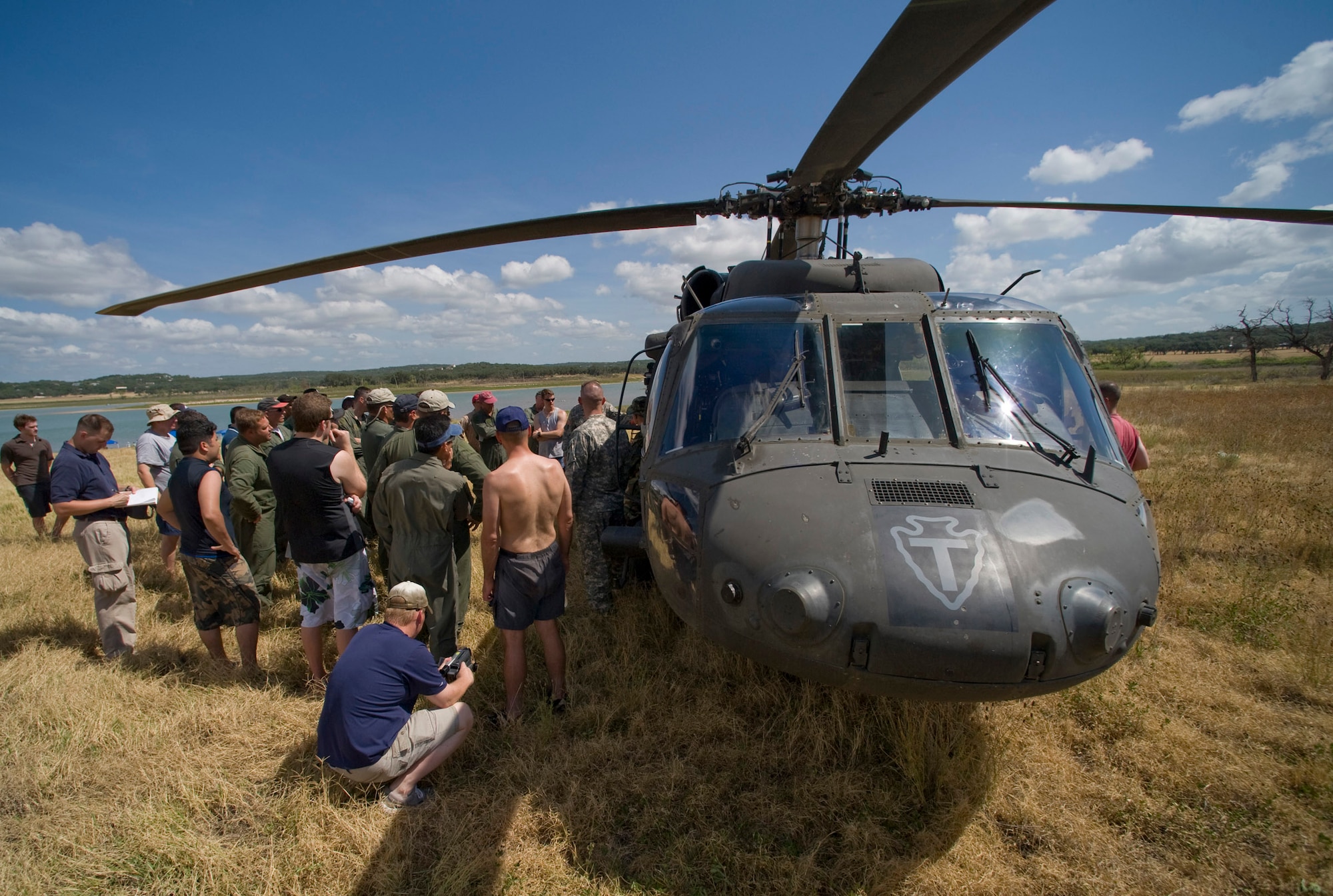 Members of the Texas Air National Guard's 149th Fighter Wing gather around a UH-60 Black Hawk for a safety briefing before the water rescue portion of their refresher aircrew water survival training at Canyon Lake near San Antonio. The Black Hawk is assigned to the 149th Aviation Regiment in San Antonio. (U.S. Air Force photo/Master Sgt. Jack Braden) 
