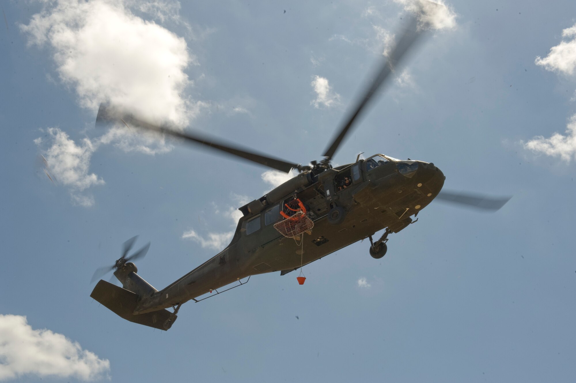 A UH-60 Black Hawk from the 149th Aviation Regiment is maneuvered in to position during refresher aircrew water survival training at Canyon Lake near San Antonio. The aircraft and crew provided the water recovery portion of the refresher training conducted by the 149th Fighter Wing. Both units are part of the Texas National Guard assigned in San Antonio.( U.S. Air Force photo/Master Sgt. Jack Braden) 