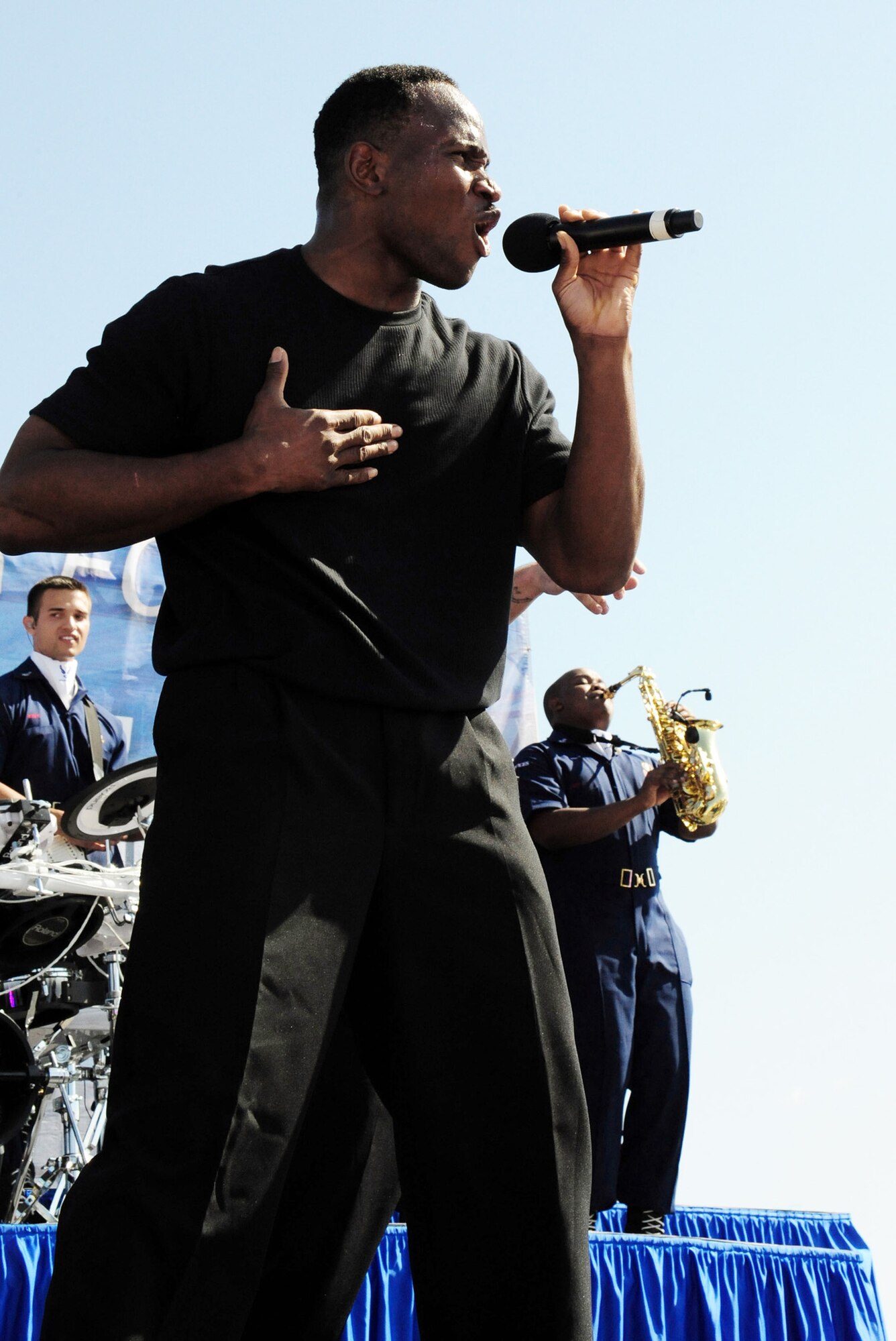 Staff Sgt. Wendell Boone Jr., a vocalist with Tops In Blue, performs during the second show of the 2009 "To Dream" tour July 10 at the Transit Center at Manas Air Base, Kyrgyzstan. During the team's visit from July 8 through 11, he was able to reunite with his wife, Tech. Sgt. Patrika Boone. Sergeant Boone, assigned to the 376th Expeditionary Logistics Readiness Squadron here, is deployed from Robins Air Force Base, Ga., while he is an air transportation apprentice with the 69th Aerial Port Squadron at Andrews AFB, Md. (U.S. Air Force photo/Staff Sgt. Tyrona Pearsall)